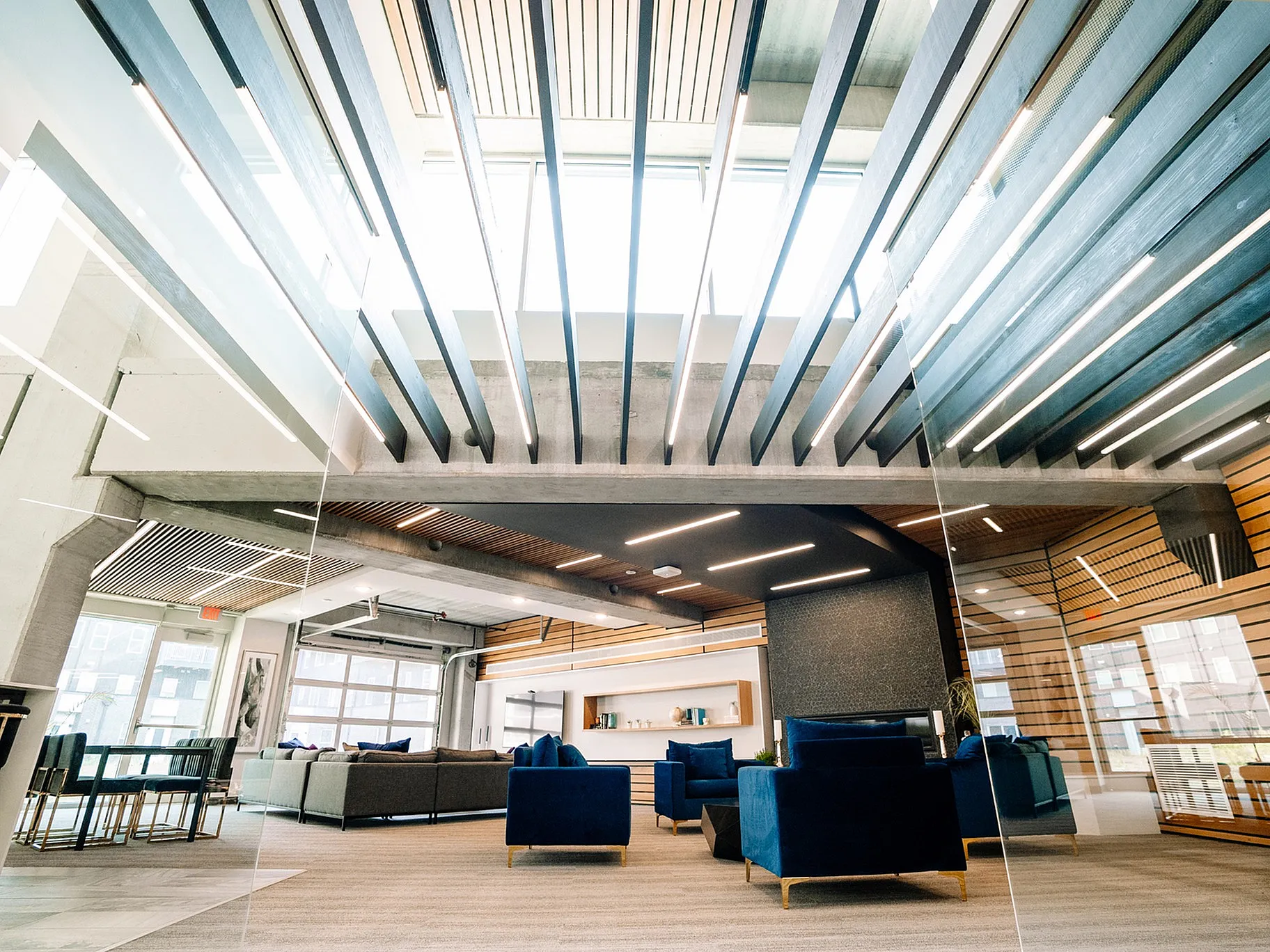 Bright and modern apartment lounge showcasing sleek architectural design, cozy seating areas, and abundant natural light.