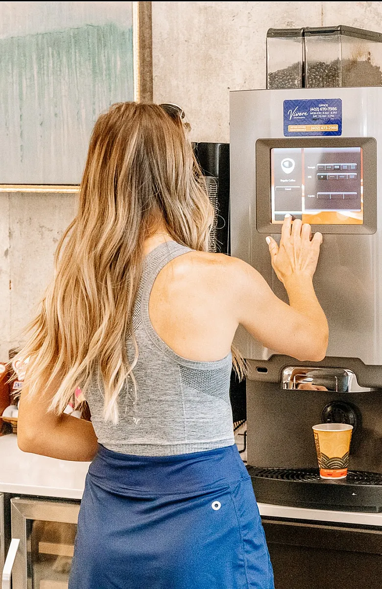 Inviting apartment kitchen with a sleek coffee machine and assorted teas, perfect for morning routines.