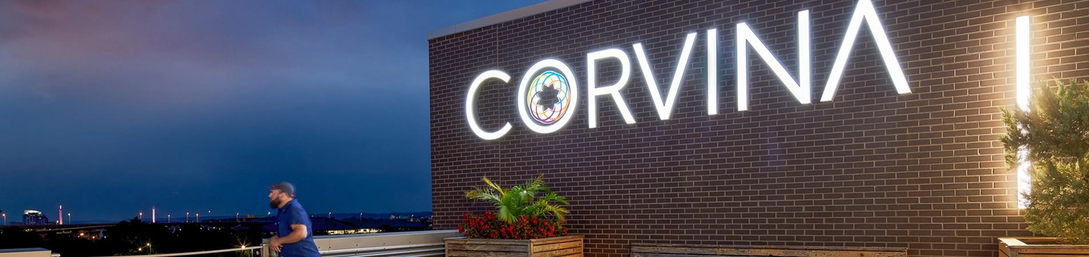 Modern rooftop terrace at the Corvina apartments featuring stylish seating and ambient lighting, perfect for sunset views.