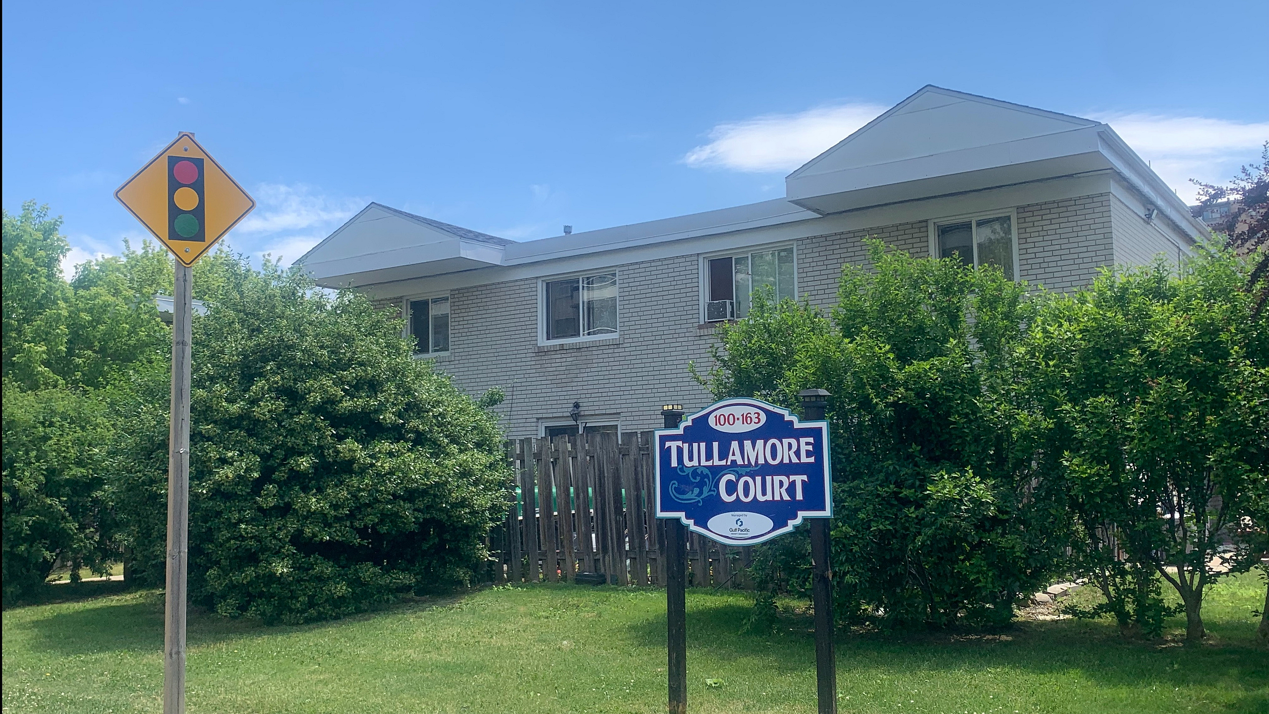 Charming Tullamore Court apartment building surrounded by lush greenery, boasting a tranquil and inviting atmosphere.