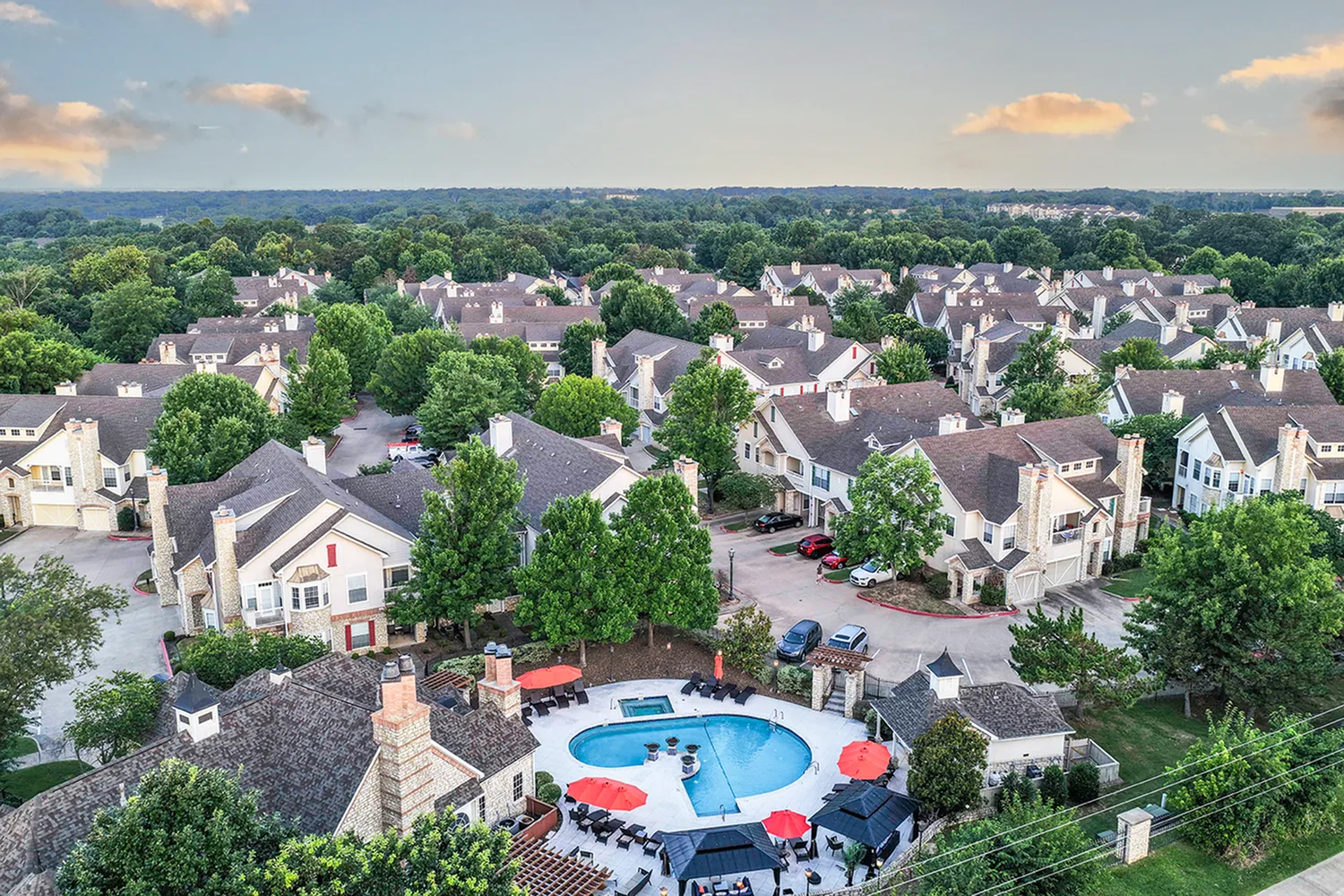 Aerial view of the pool with cabanas and the clubhouse at Stone Manor Apartment Homes in Rogers, AR