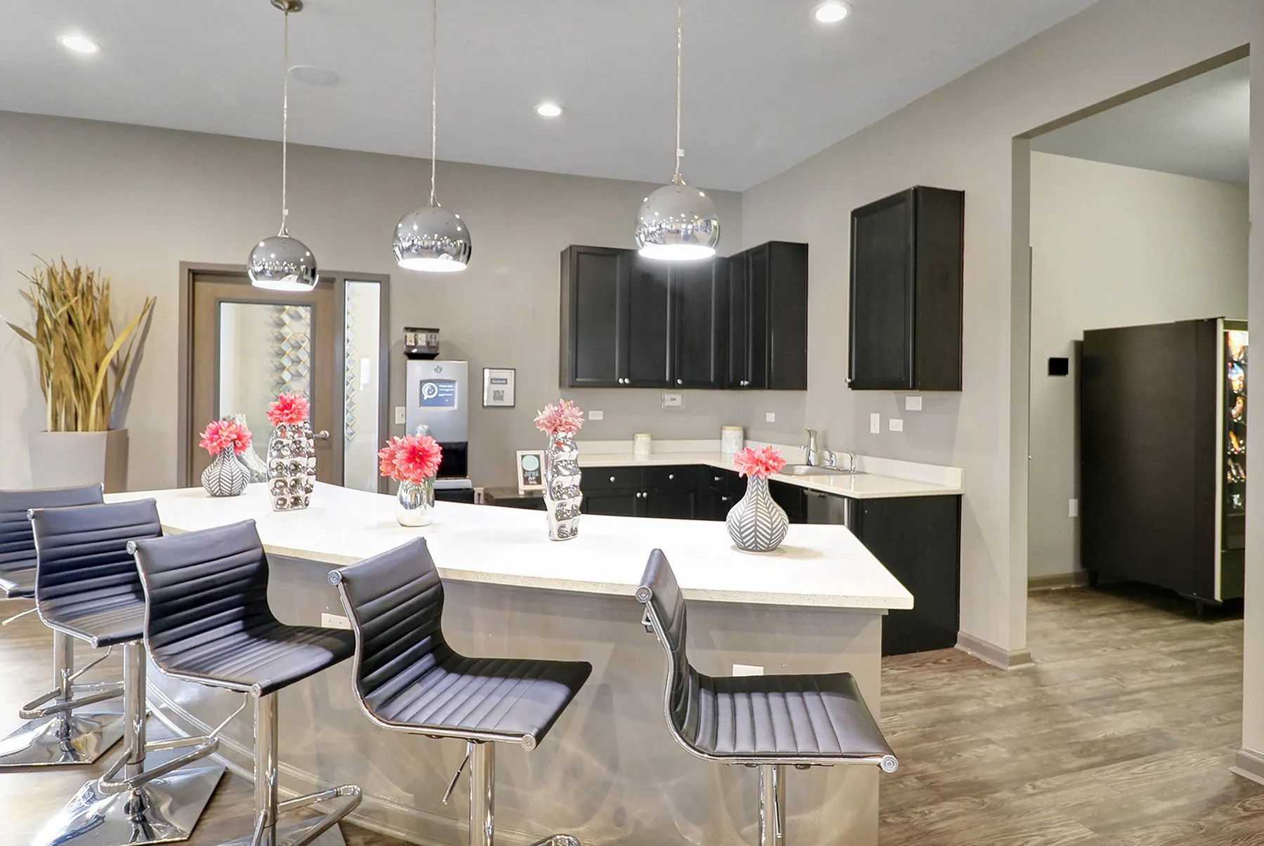 Modern kitchen design with sleek countertops, chic barstools, and stylish pendant lighting, creating a welcoming and elegant atmosphere.