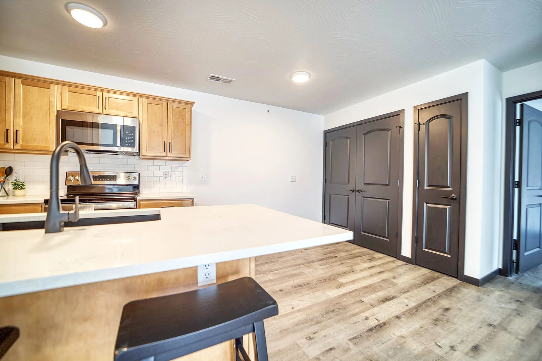 Modern kitchen with sleek cabinetry, stainless steel appliances, and an elegant island counter, perfect for entertaining.