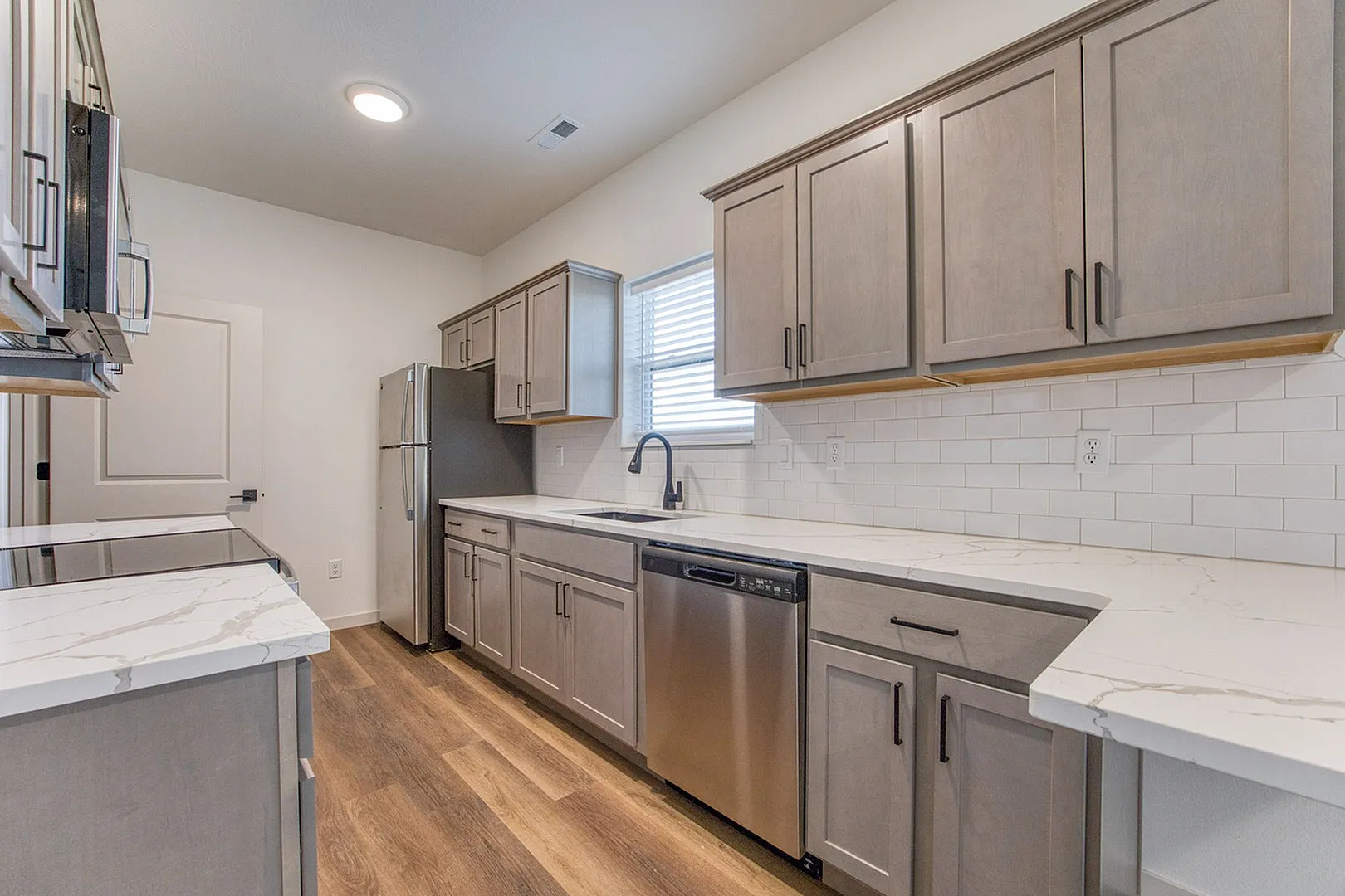 Sleek modern kitchen with stainless steel appliances, elegant marble countertops, and stylish cabinetry, perfect for culinary creativity.