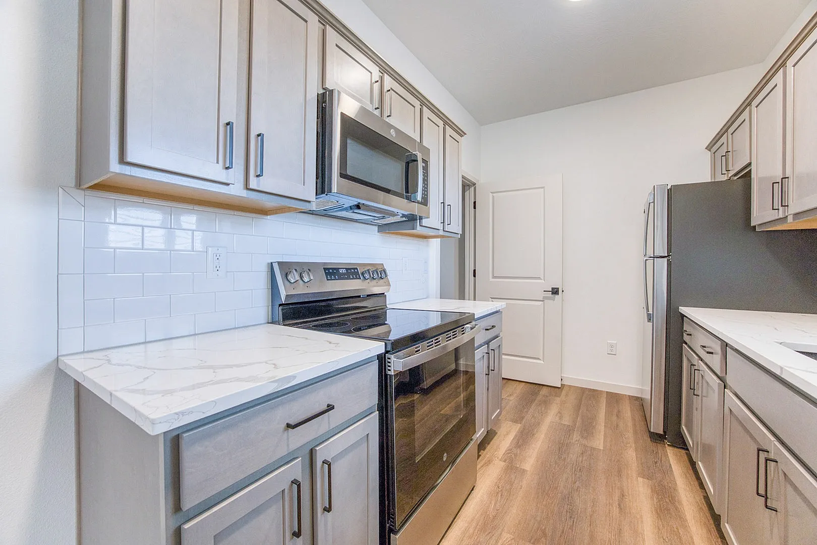 Modern kitchen with sleek cabinets, stainless steel appliances, and elegant marble countertops.