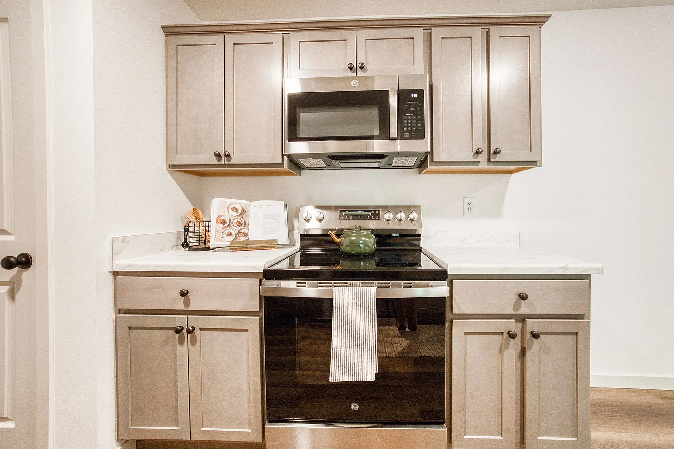 Modern kitchen with sleek cabinets, stainless steel appliances, and a polished marble countertop, ideal for culinary enthusiasts.