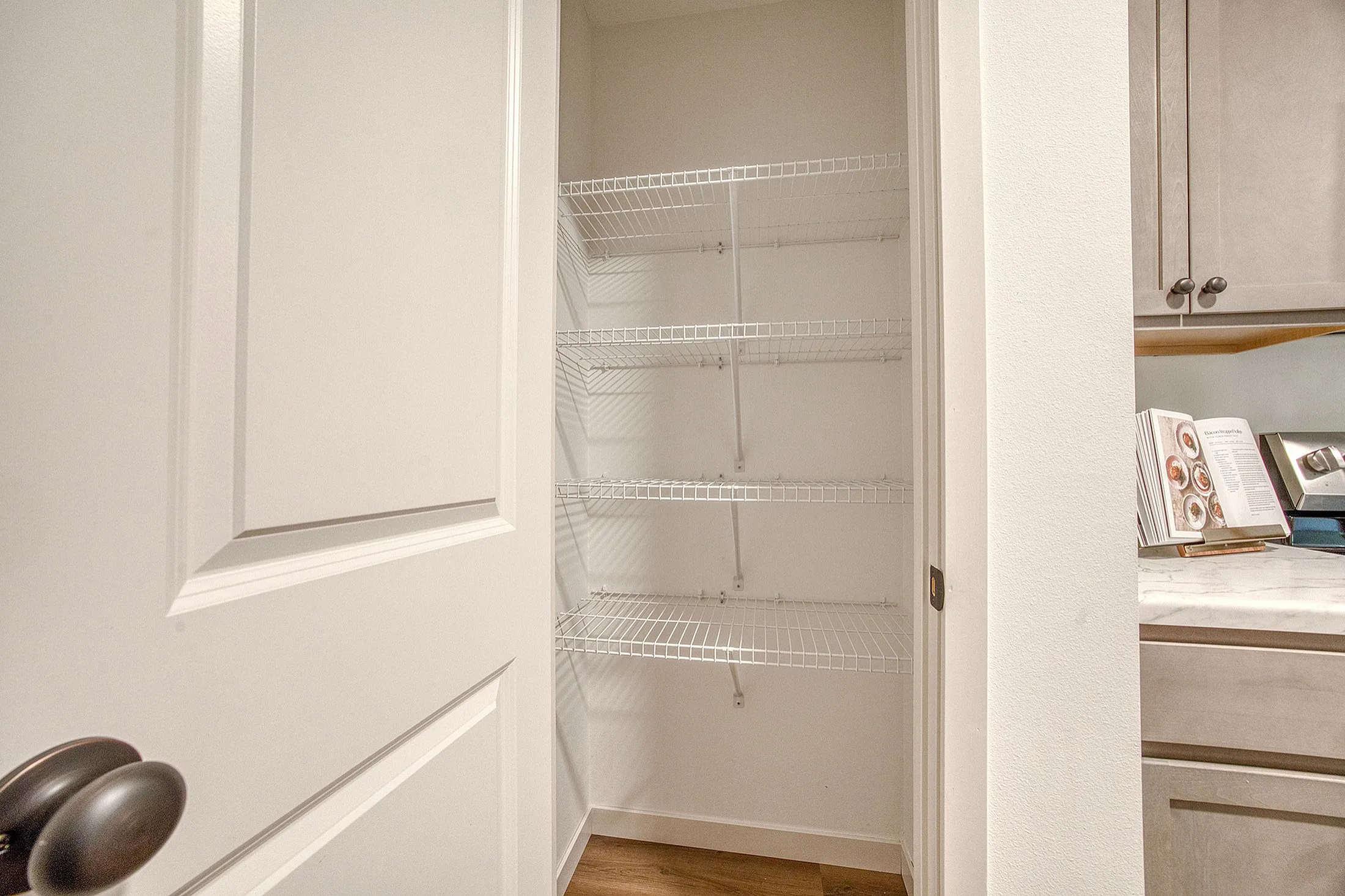 Inviting pantry space with sleek wire shelving, perfect for organized kitchen storage.