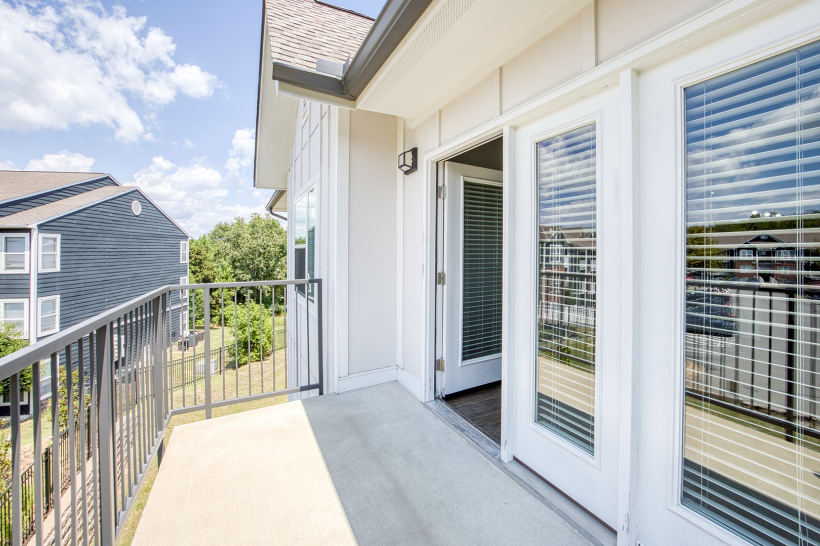 Bright and inviting balcony with French doors, offering scenic views and plenty of sunshine, perfect for relaxation.