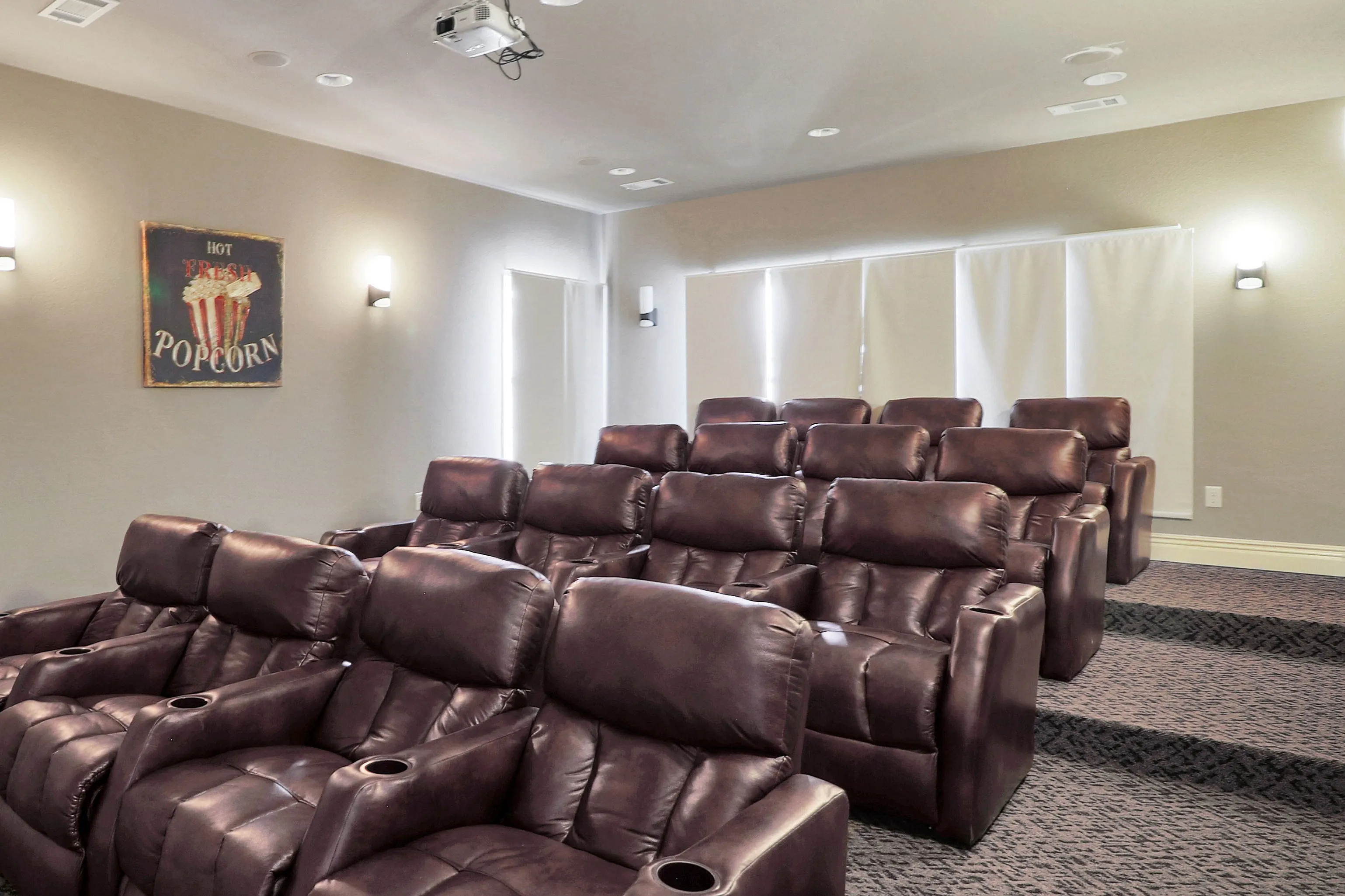 Luxurious home theater with plush leather recliners and state-of-the-art projection.