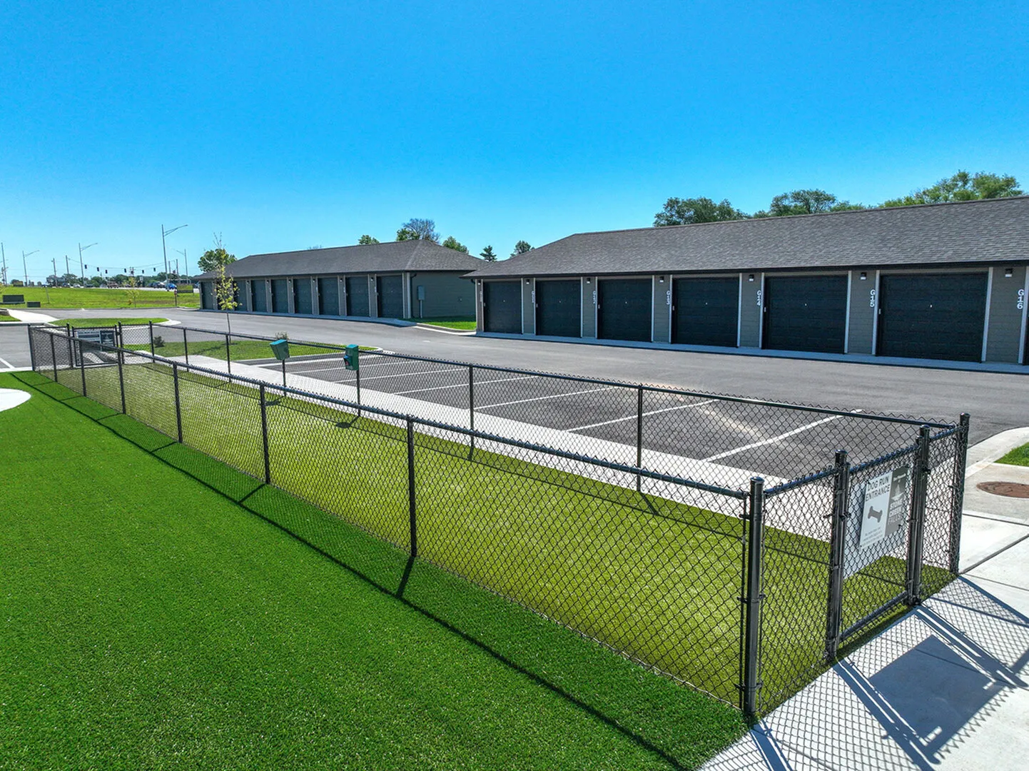 Luxurious apartment complex featuring sleek storage units with easy access and scenic greenery.