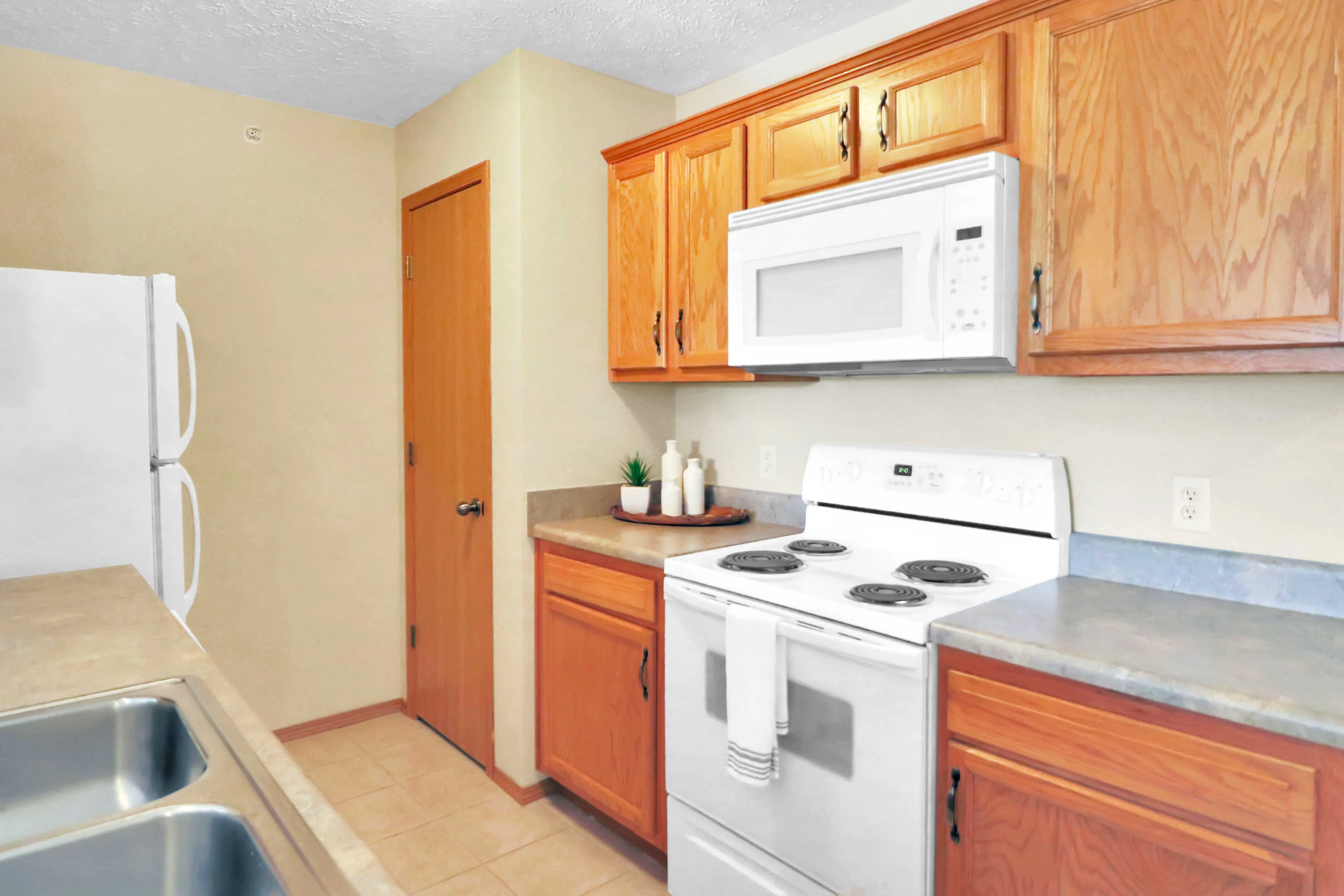 Charming kitchen with warm wooden cabinets, sleek countertops, and modern appliances creating an inviting culinary space.