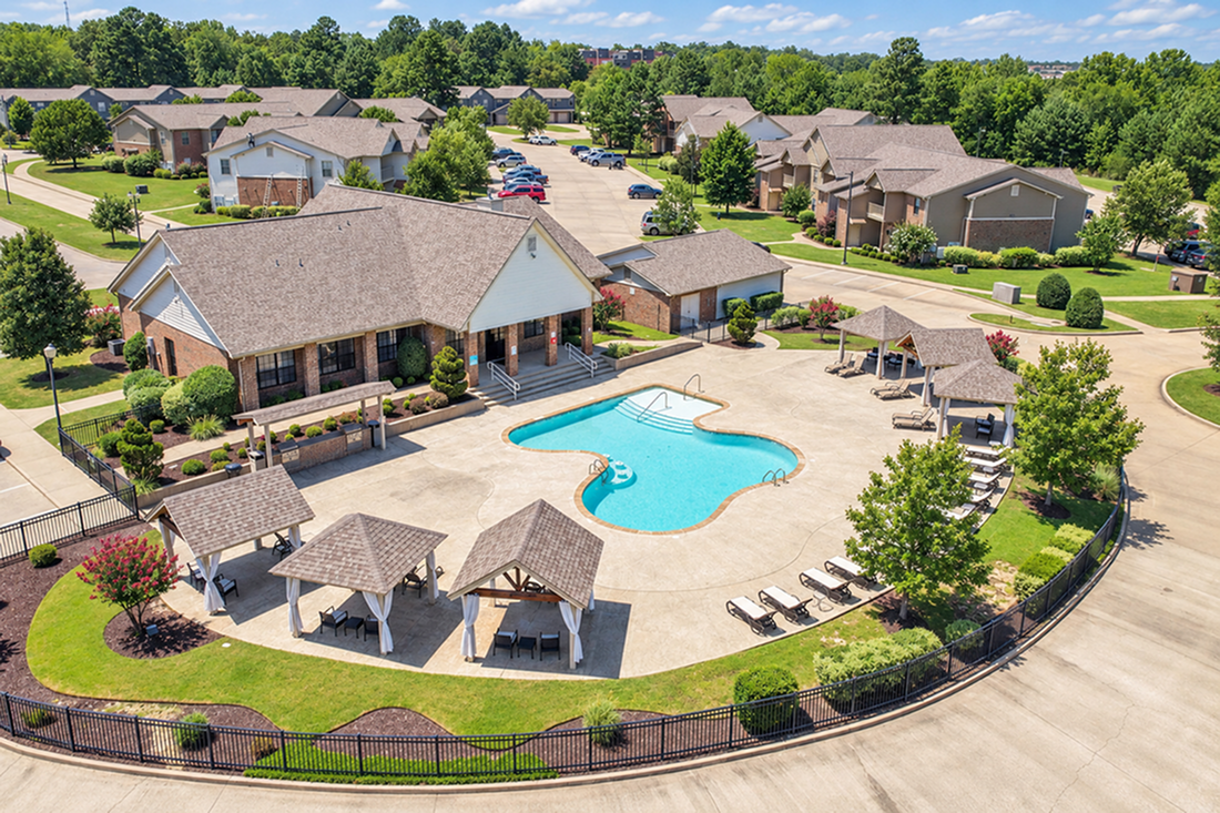 Inviting apartment community featuring a pristine swimming pool, stylish cabanas, and lush green spaces for relaxation and enjoyment.