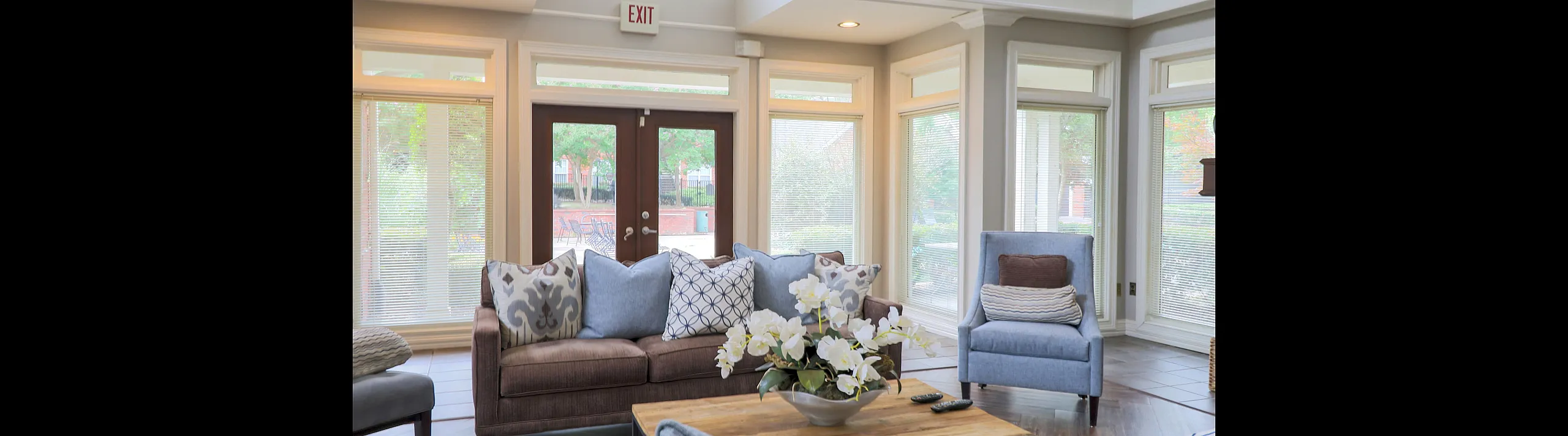 Bright and welcoming living room with elegant decor, plush seating, and large windows providing ample natural light.