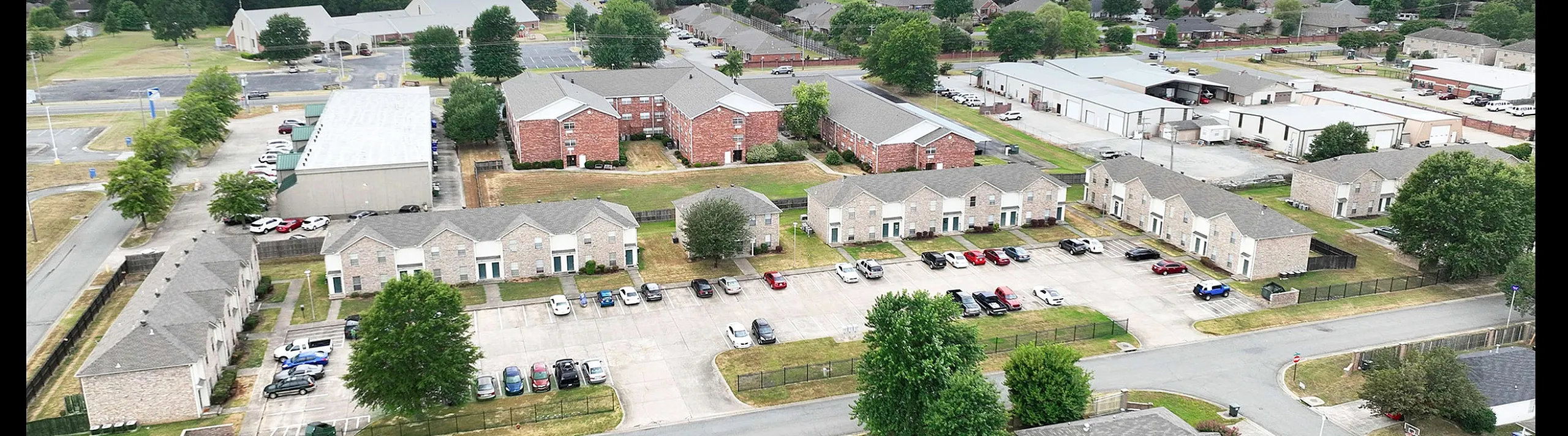 Charming suburban apartment complex surrounded by lush greenery and a vibrant community atmosphere.