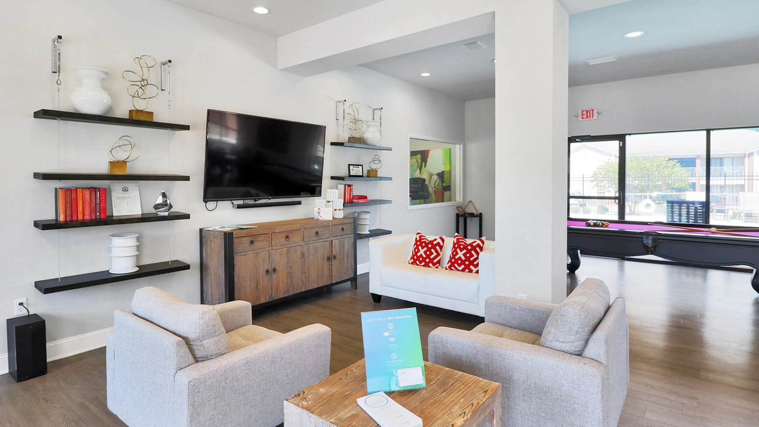 Modern living area featuring elegant decor, cozy seating, and a pool table, perfect for relaxation and entertainment.