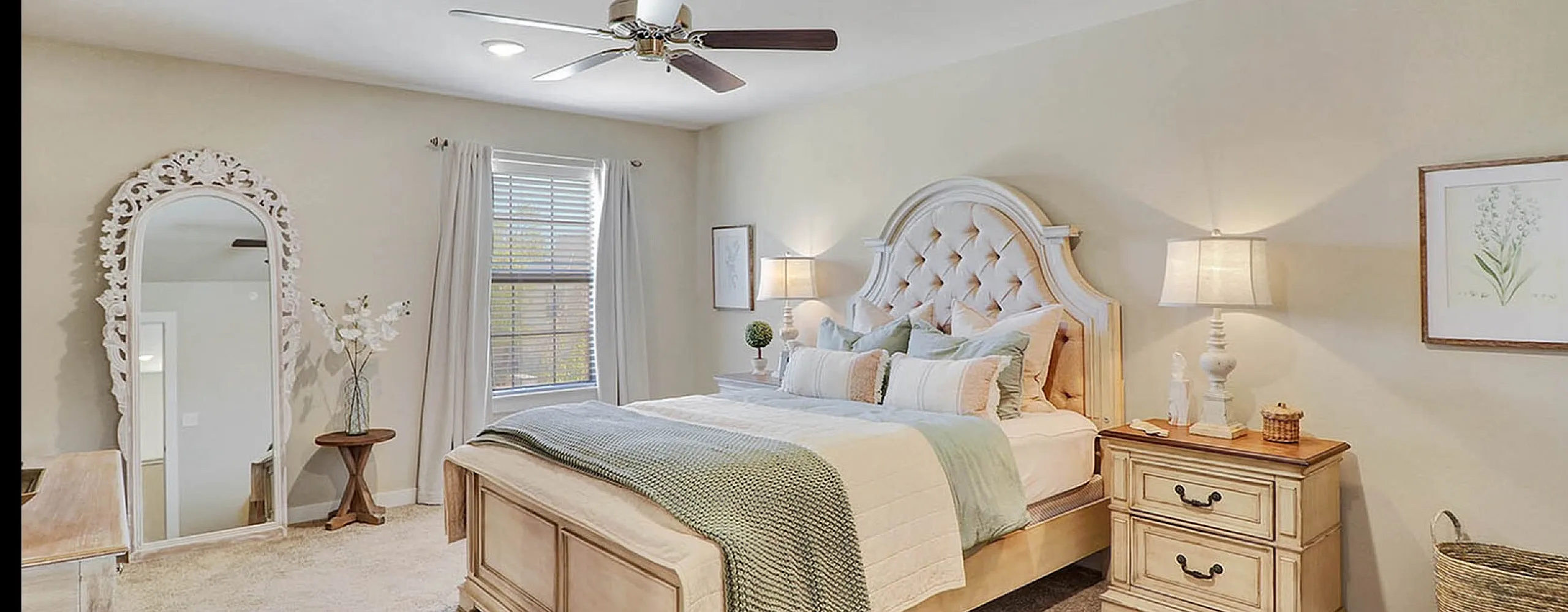 Elegant bedroom with a plush, tufted bed, soft lighting, and charming decor for a cozy ambiance.