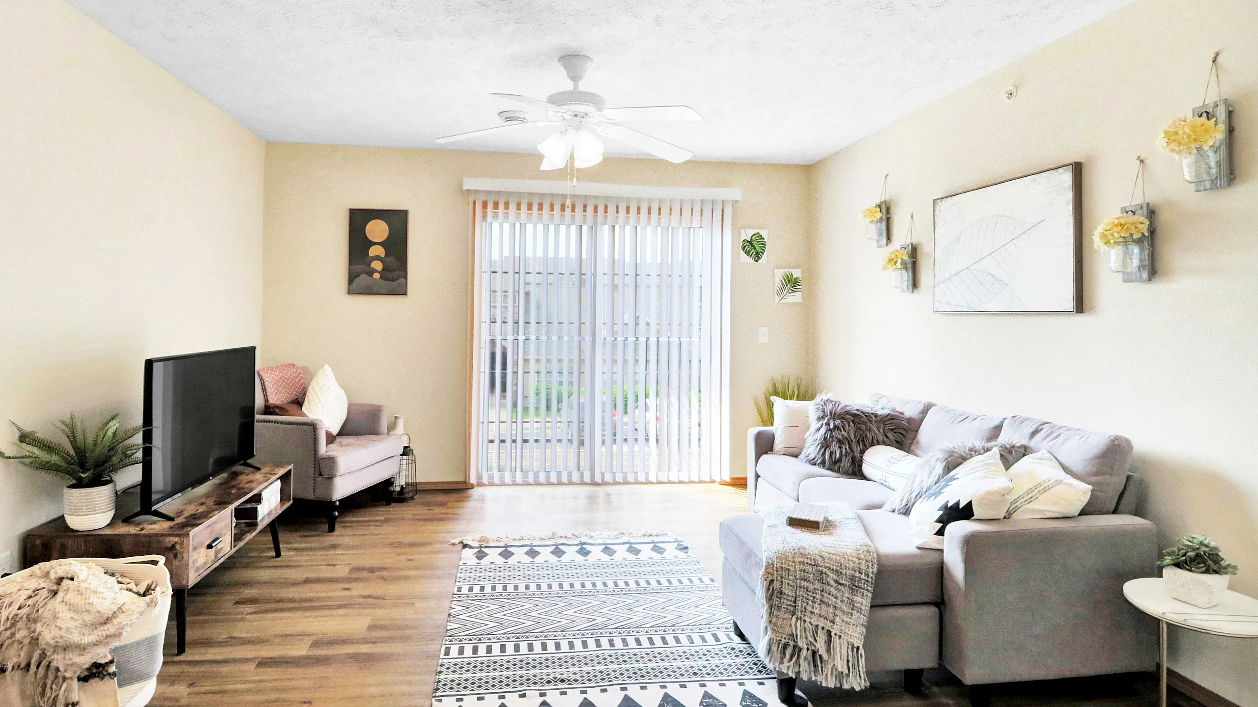Bright and inviting living room with modern decor, cozy sectional sofa, stylish rug, and natural light streaming through large sliding doors.