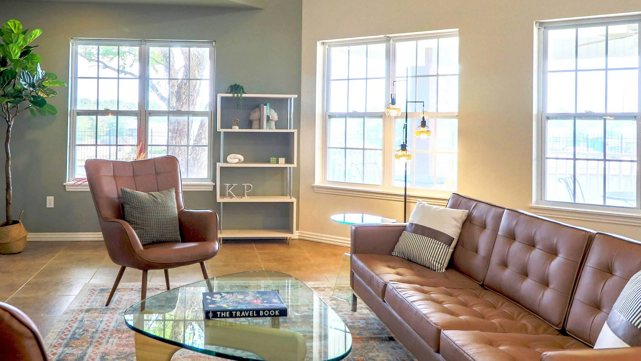 Bright and inviting living room with large windows, modern seating, and elegant decor offering a cozy yet stylish atmosphere.