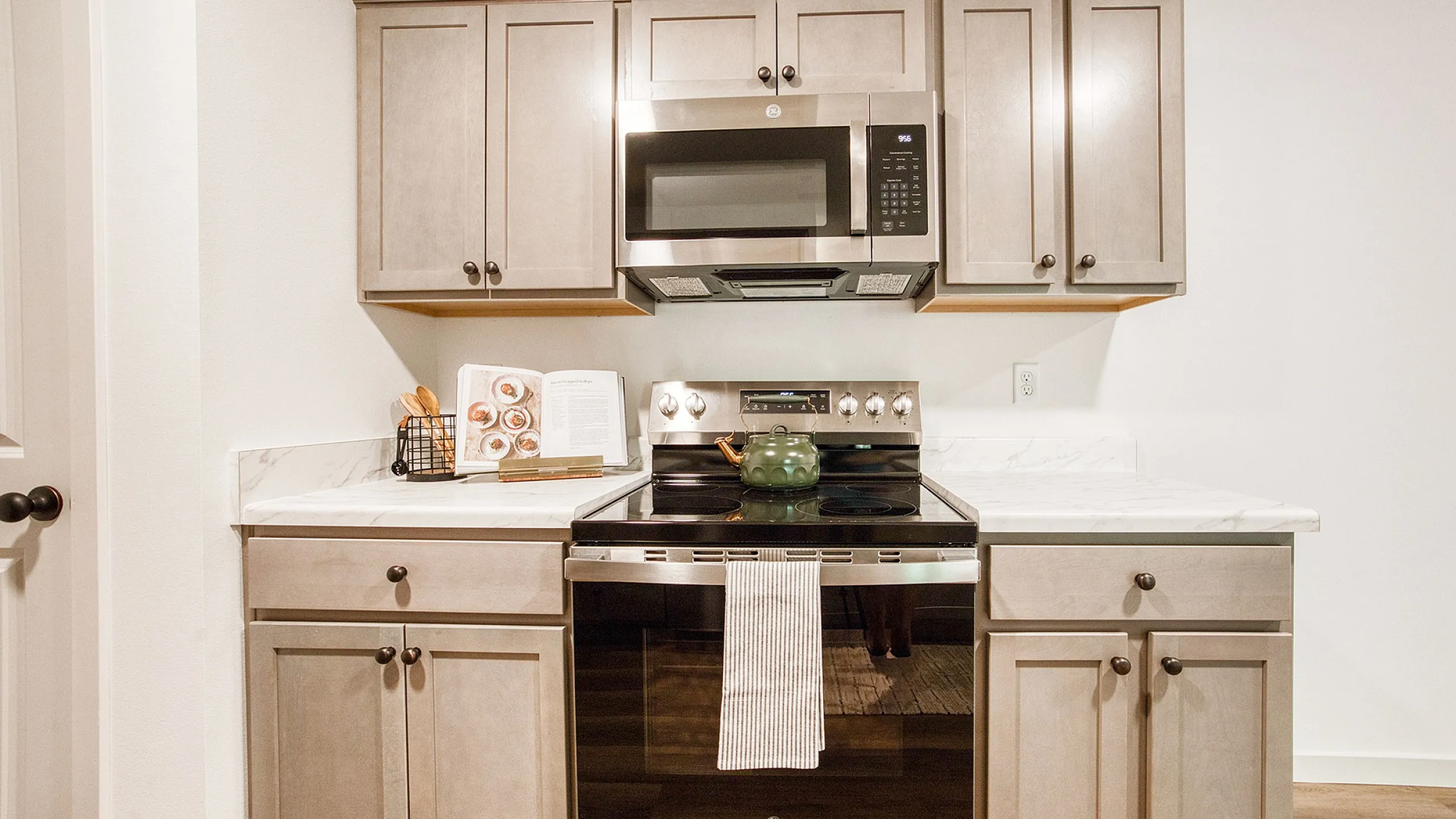 Modern kitchen with elegant cabinetry, stainless steel appliances, and beautiful marble countertops.