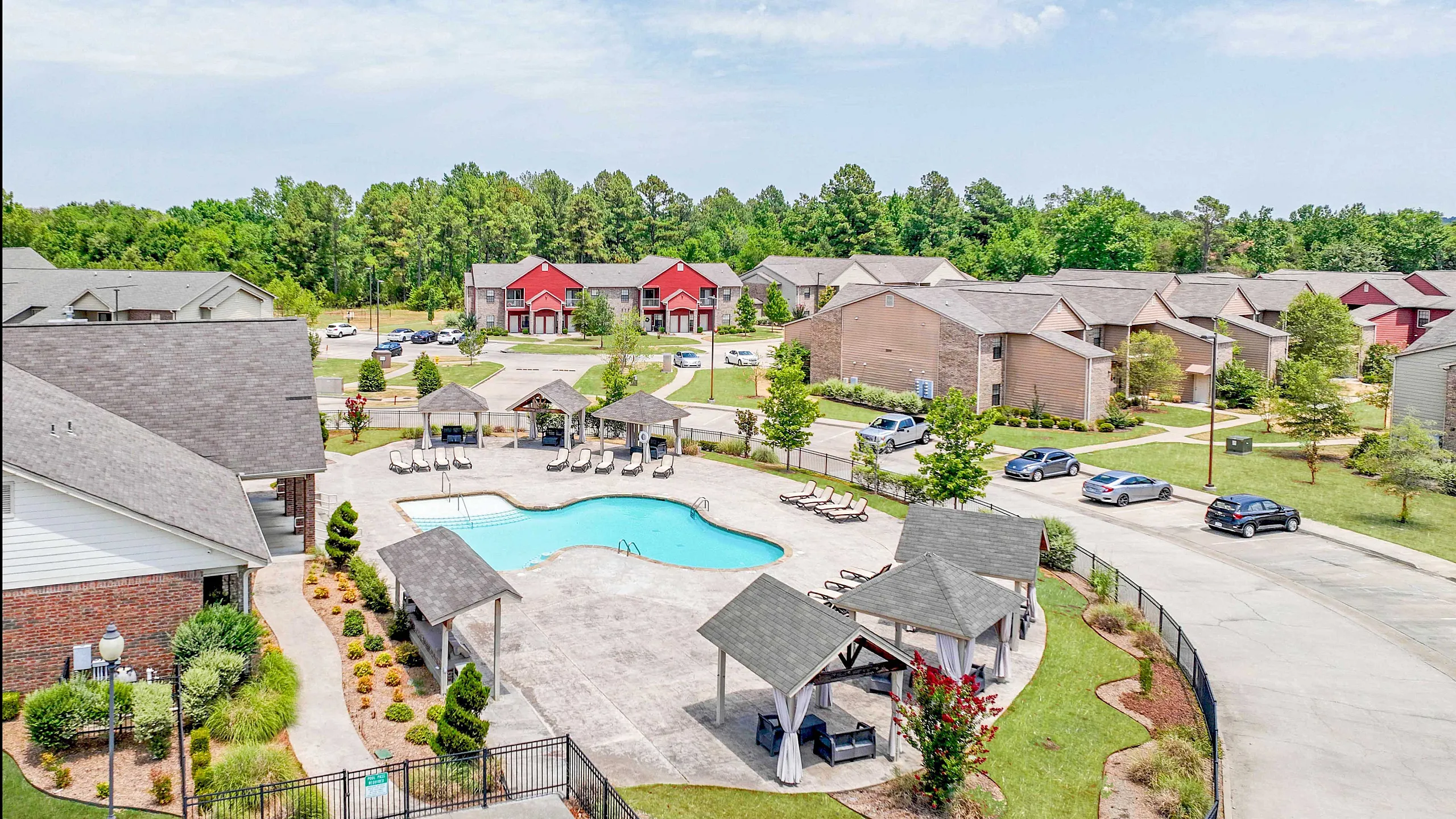 Charming apartment community featuring a sparkling swimming pool, cozy poolside pavilions, and lush landscaped surroundings ideal for relaxation and leisure.
