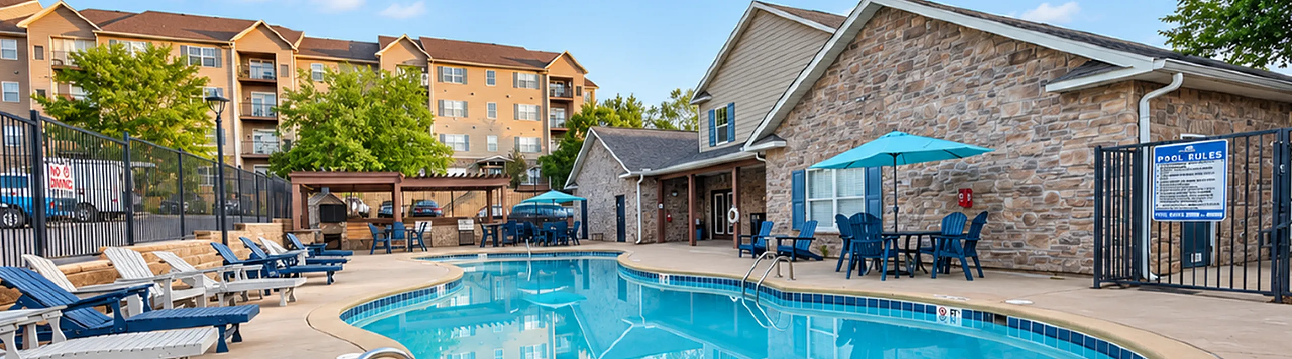 Inviting community pool area with loungers, vibrant umbrellas, and a charming clubhouse, perfect for relaxation and social gatherings.