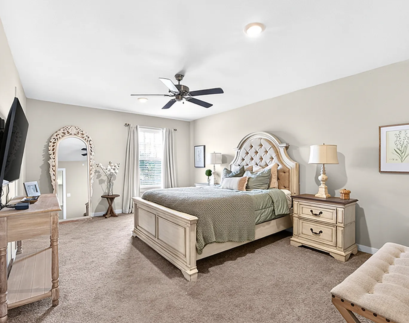 Elegant bedroom with plush carpet, chic wooden furniture, and a stylish ceiling fan, creating a serene retreat.