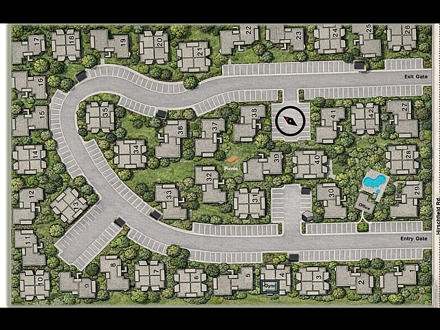 Charming aerial view of Windsong Village showcasing a landscaped layout with numerous buildings, winding roads, and amenities like a picnic area, pool, and gym in Spring, TX.