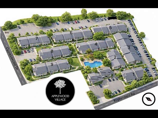 Aerial view of Applewood Village showcasing a modern apartment complex with nine buildings, landscaped gardens, parking spaces, a central swimming pool, and amenities like a gym and office.