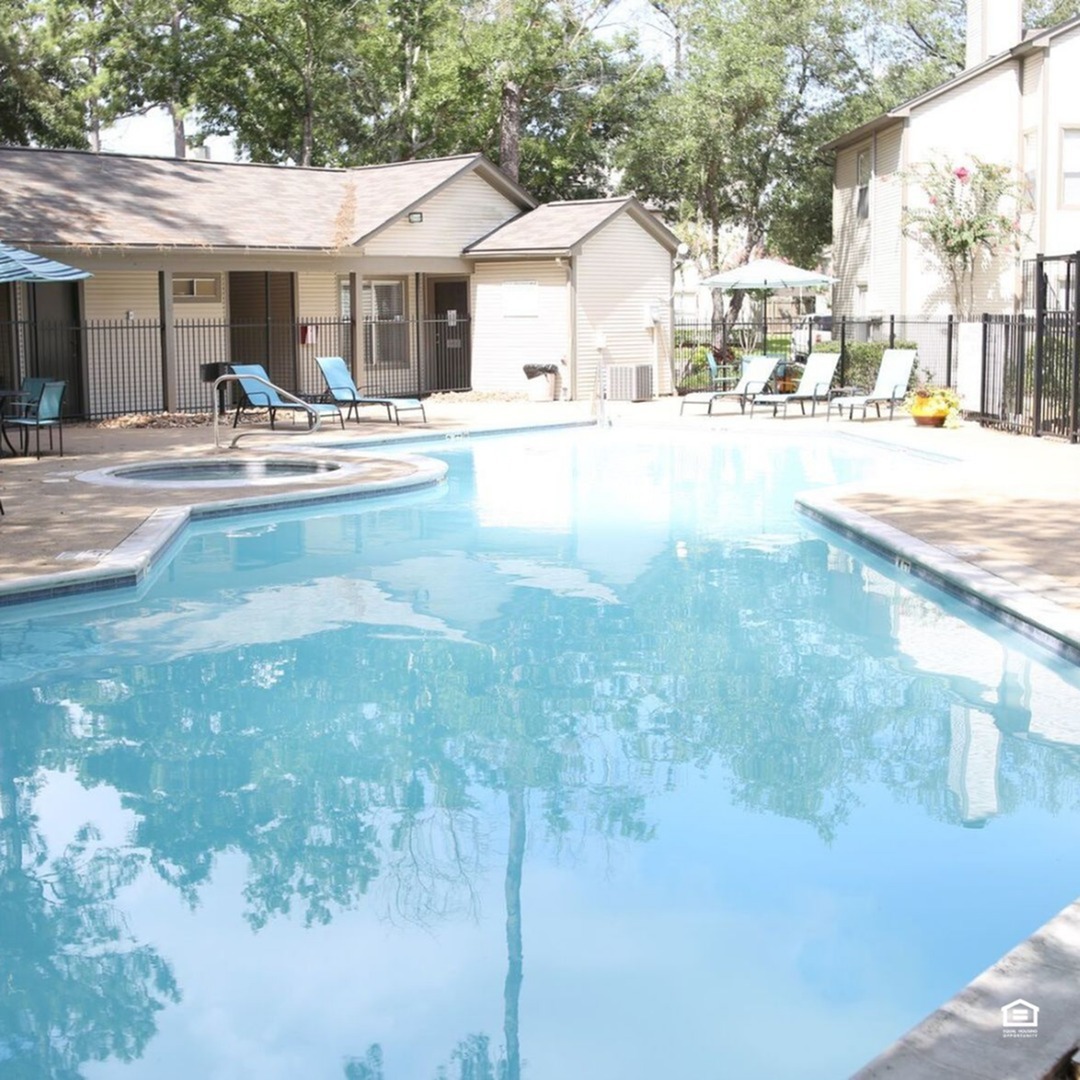 Inviting outdoor pool area with crystal-clear water, sun loungers, and lush greenery, ideal for relaxation and leisure.