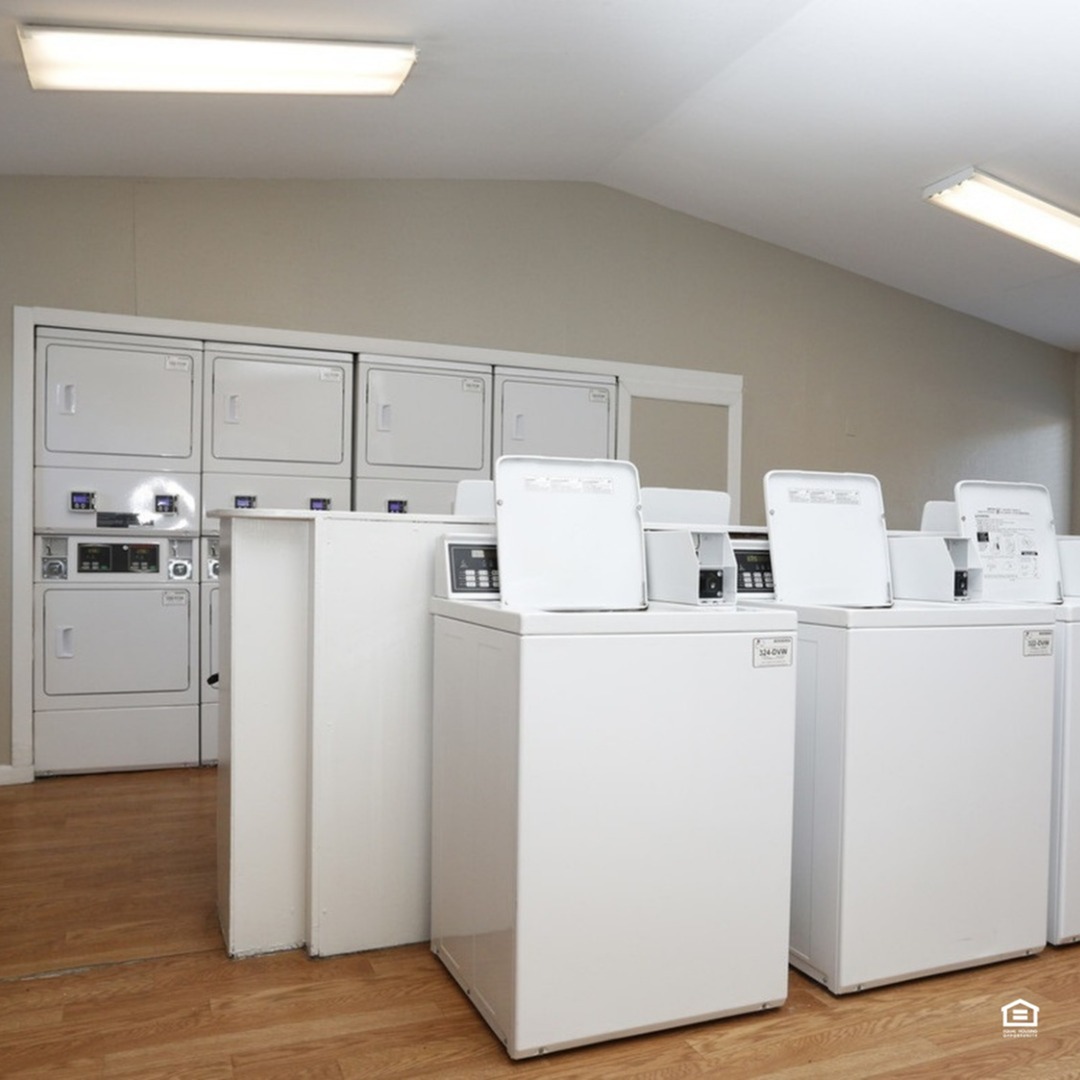 Bright and spacious laundry room with modern washers and dryers, perfect for convenient apartment living.