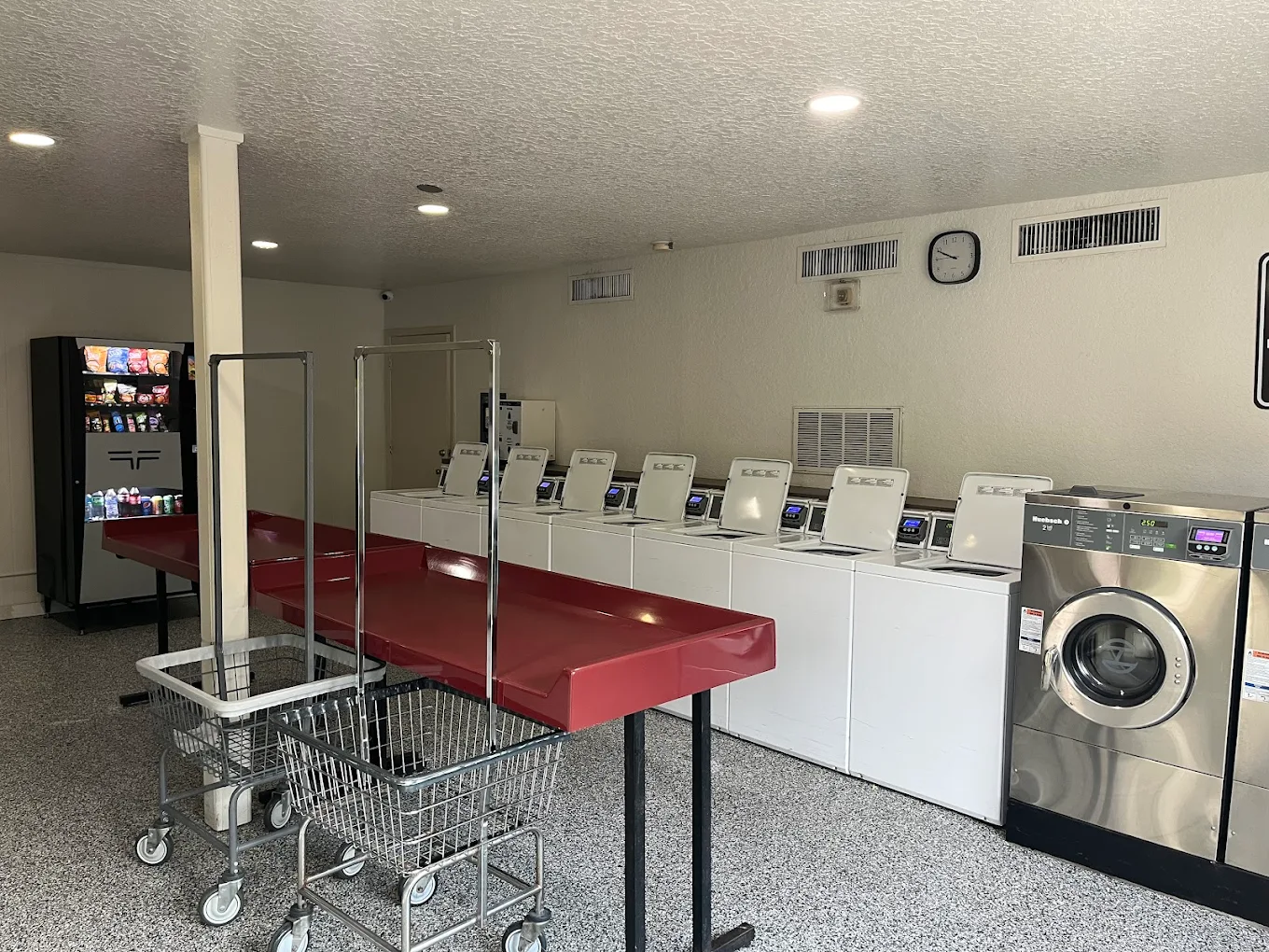 Bright and spacious laundry room with modern washers and dryers, perfect for convenient apartment living.