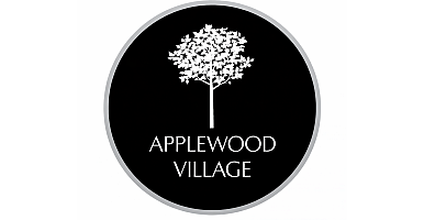 Elegant Applewood Village logo featuring a stylized tree in white on a sophisticated black background.