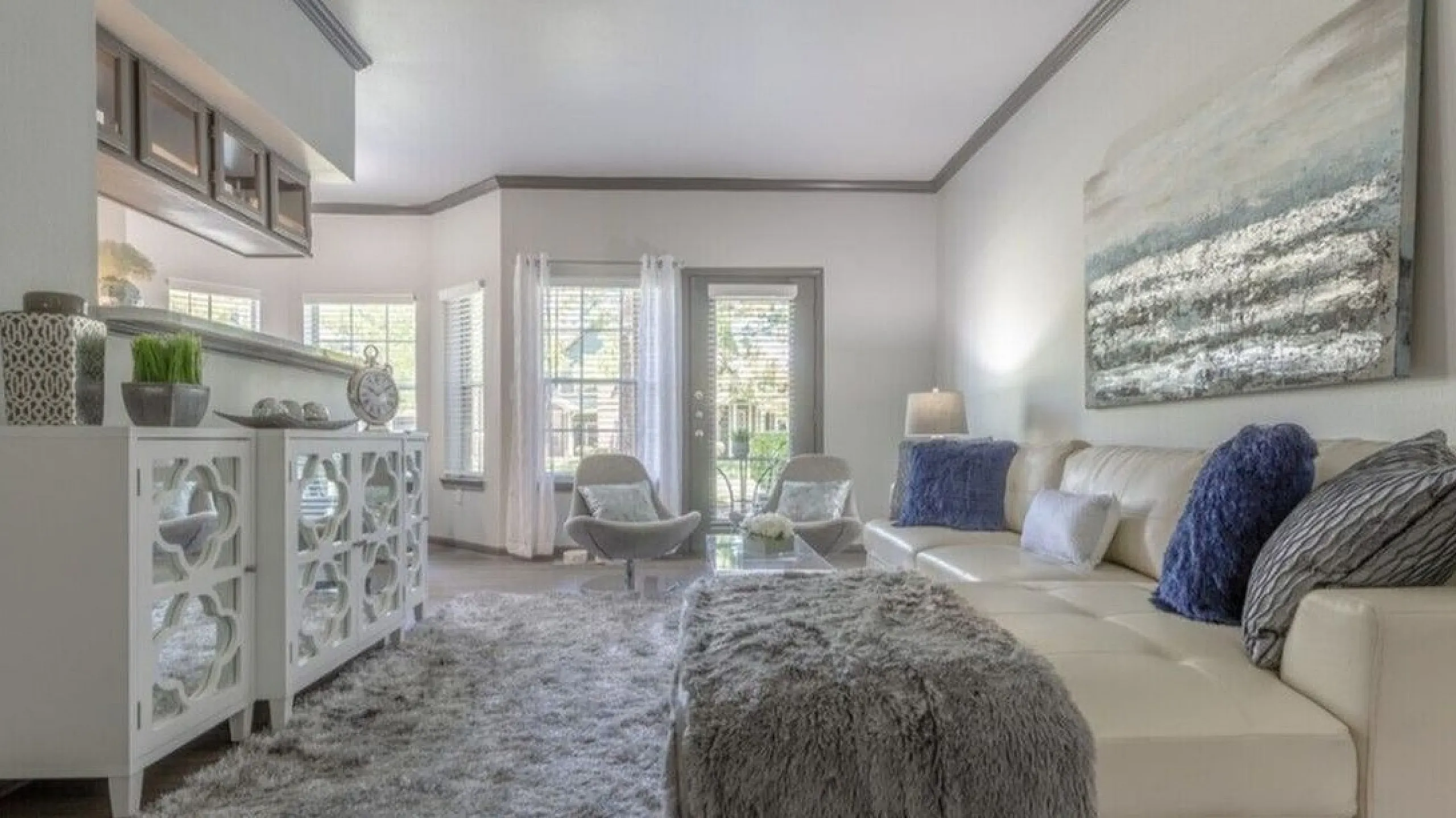 Inviting living room with chic decor, plush seating, and sunlit windows enhancing the elegant atmosphere.