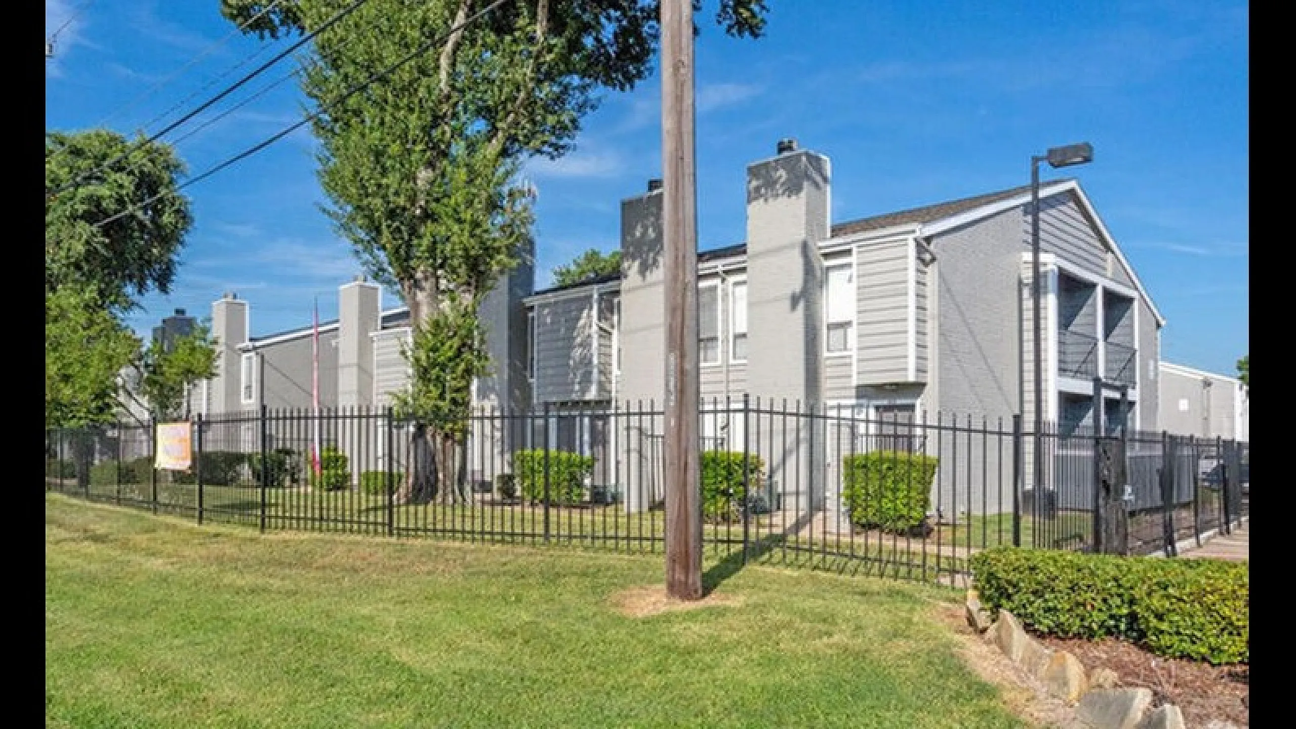 Charming apartment building in a serene setting, featuring contemporary architecture with lush greenery and a secure gated entrance.
