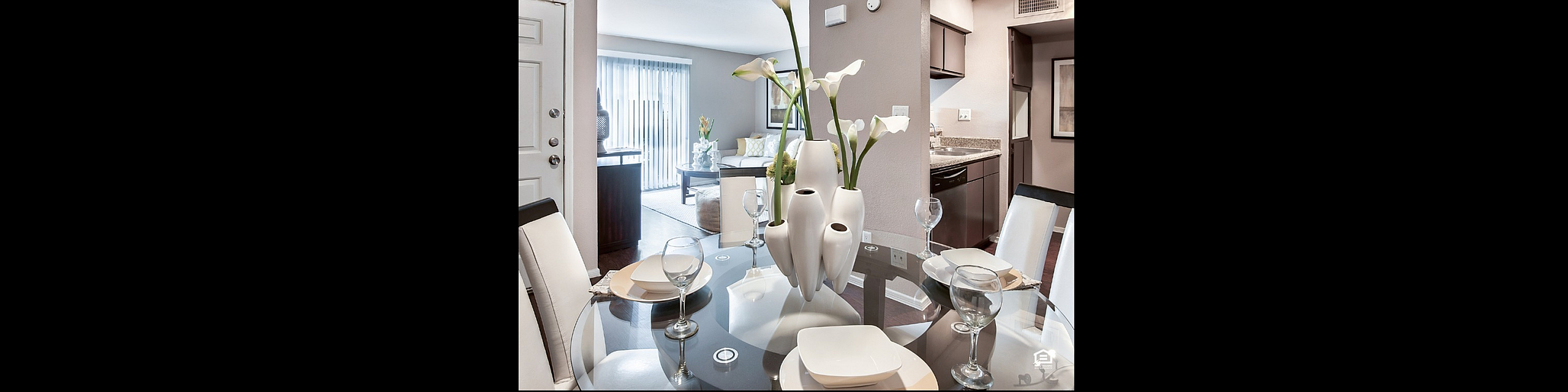 Elegant open-concept apartment with modern dining area, stylish living room, and well-equipped kitchen, perfect for comfortable living.