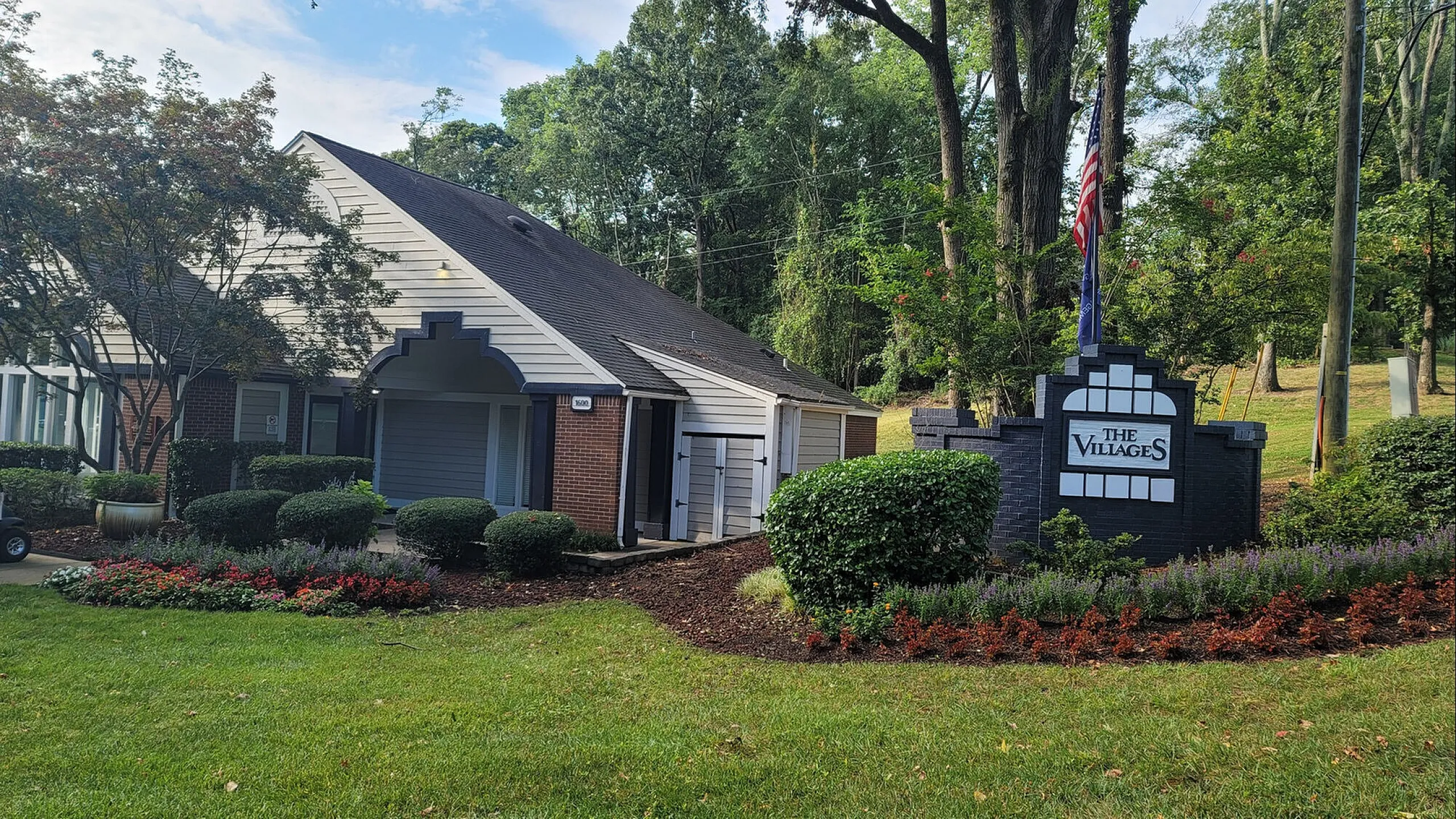 Charming suburban home nestled in lush greenery featuring a welcoming entrance at The Villages, exuding tranquility and elegance.
