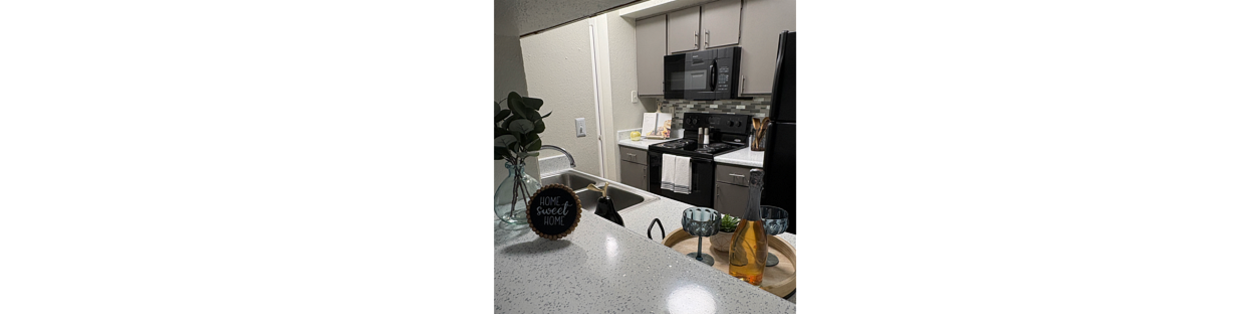 Chic modern kitchen with sleek countertops, stylish cabinetry, and cozy decor, perfect for entertaining.