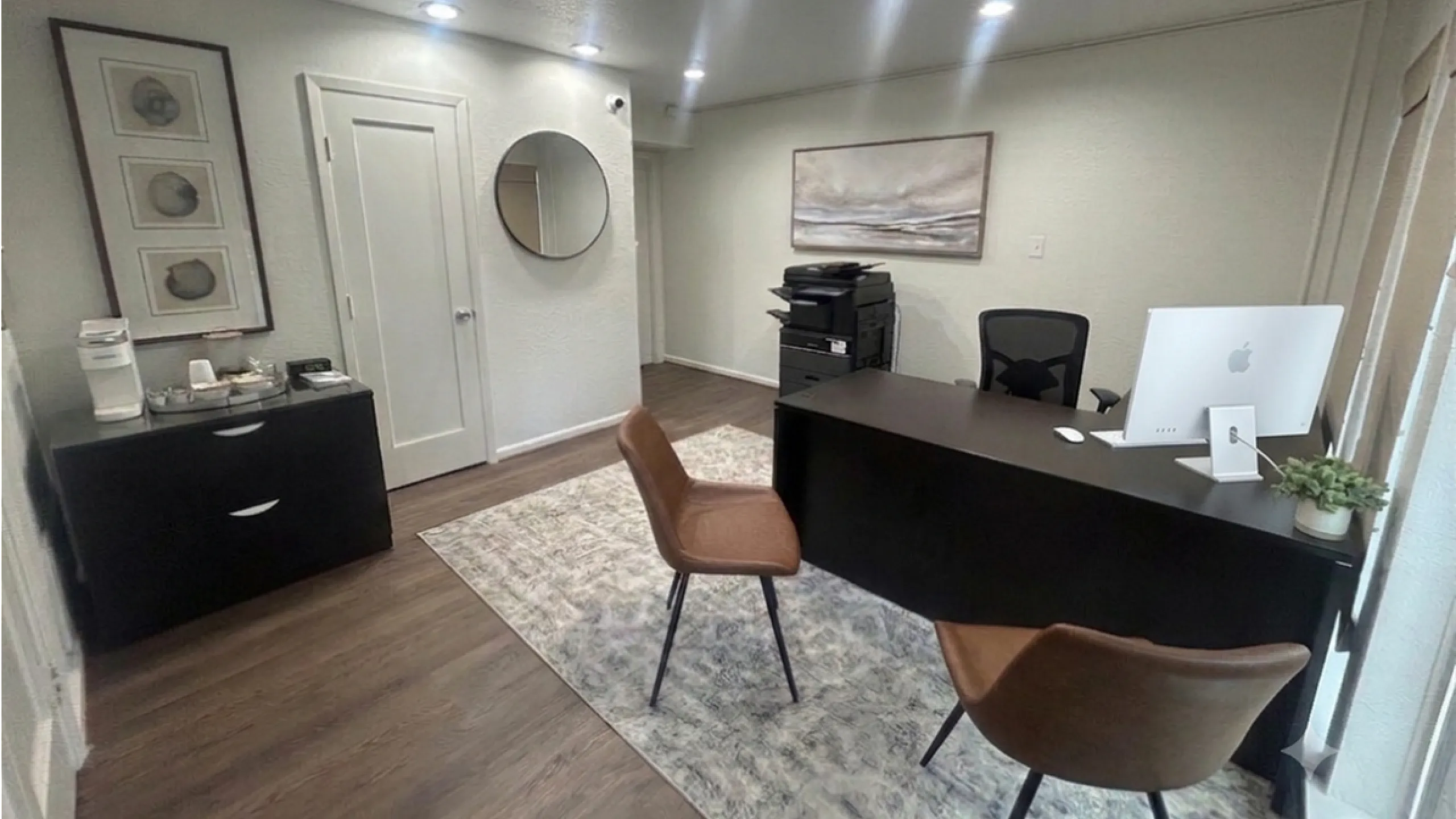 Chic modern office space featuring sleek desk, comfortable seating, and stylish decor in a bright setting.