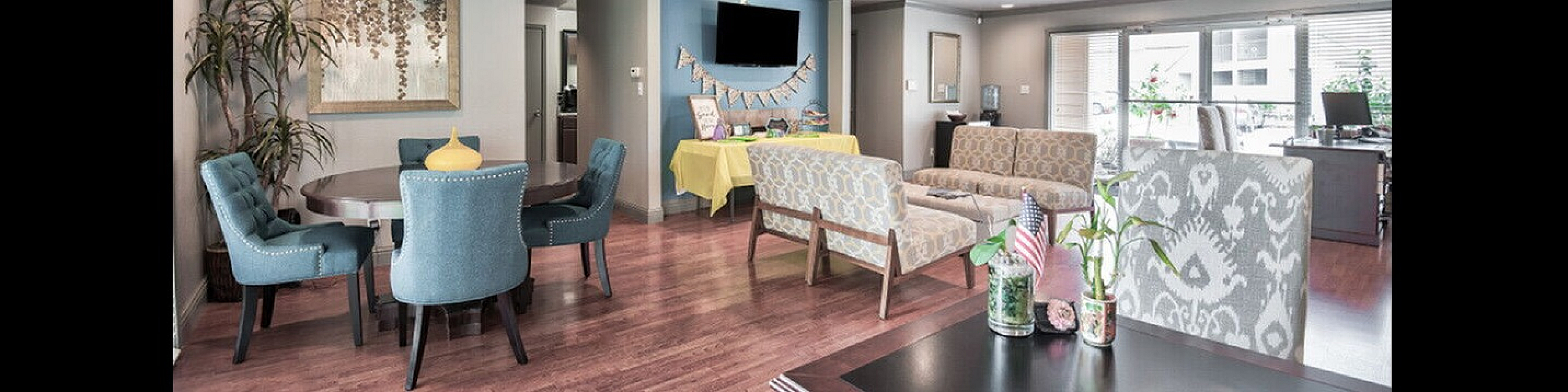 Chic community lounge with elegant seating, vibrant decor, and ample natural light through large windows.