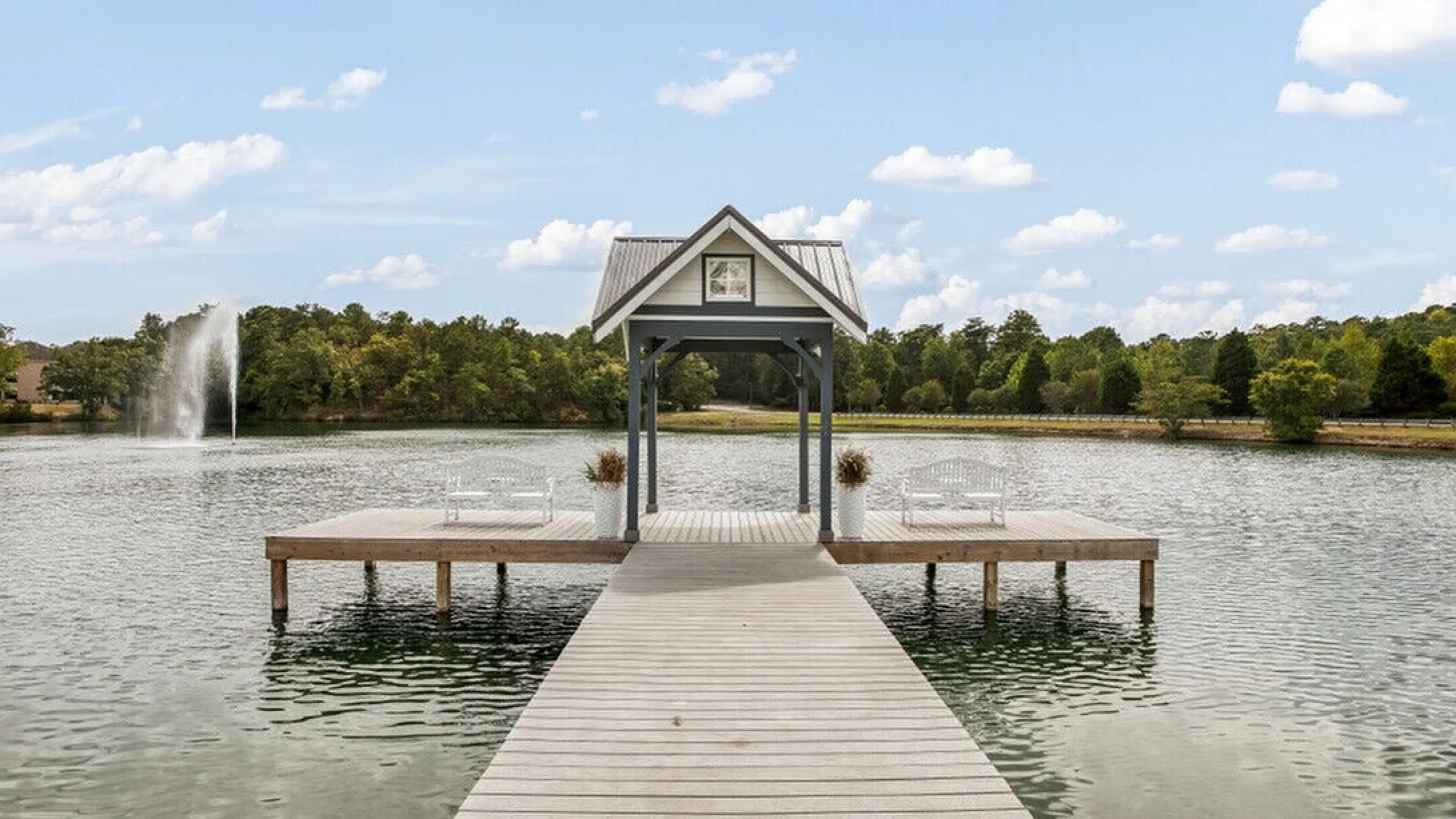Tranquil lakeside pier with a charming gazebo and scenic water views, perfect for relaxation.