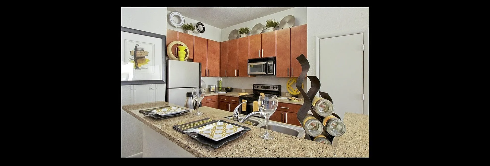 Modern kitchen boasting sleek granite countertops, stainless steel appliances, and warm wooden cabinetry, perfect for culinary delights.
