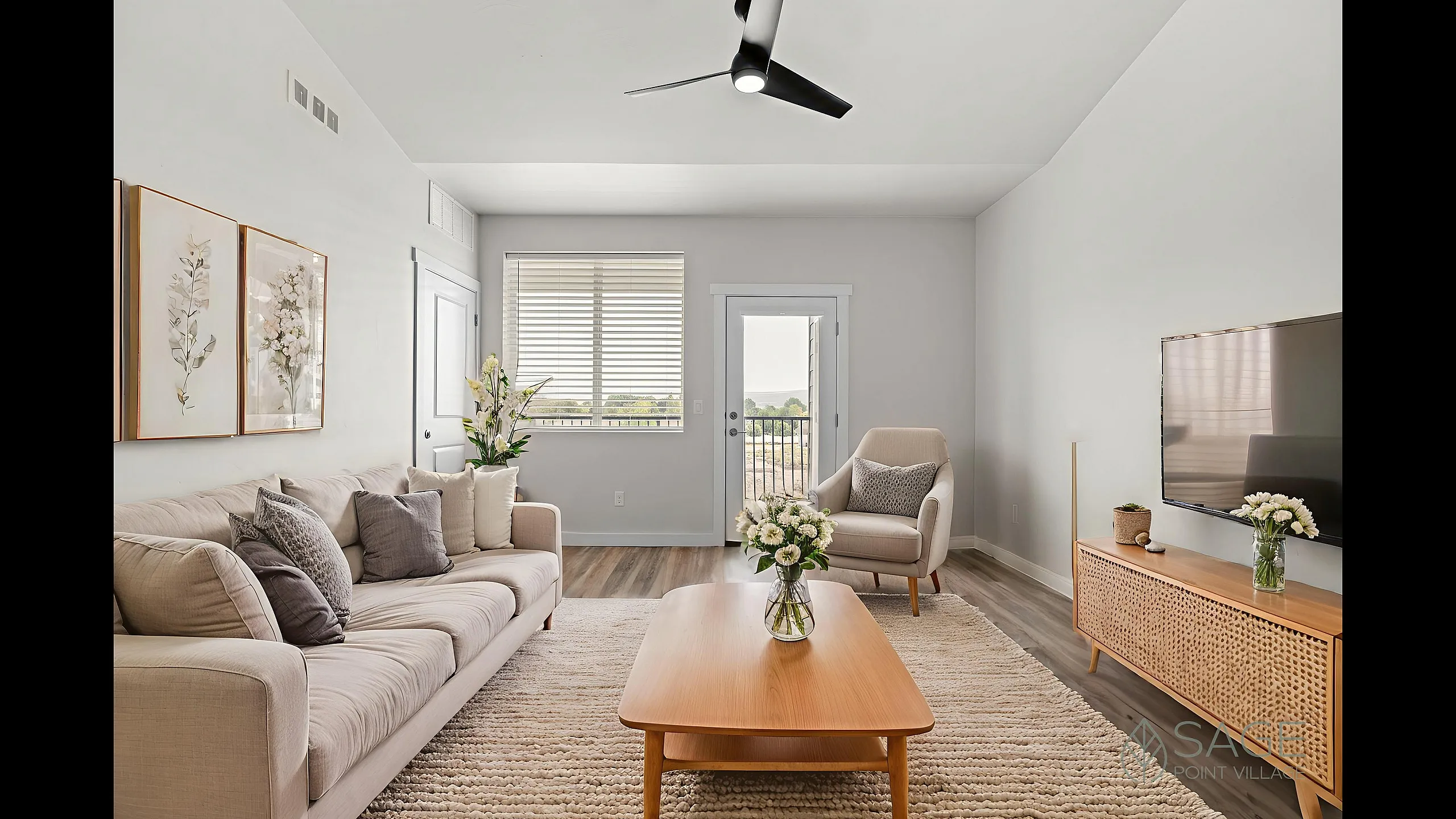 Bright and elegant living room with modern decor, featuring a cozy beige sofa, stylish armchair, large flat-screen TV, and refreshing greenery by the window.