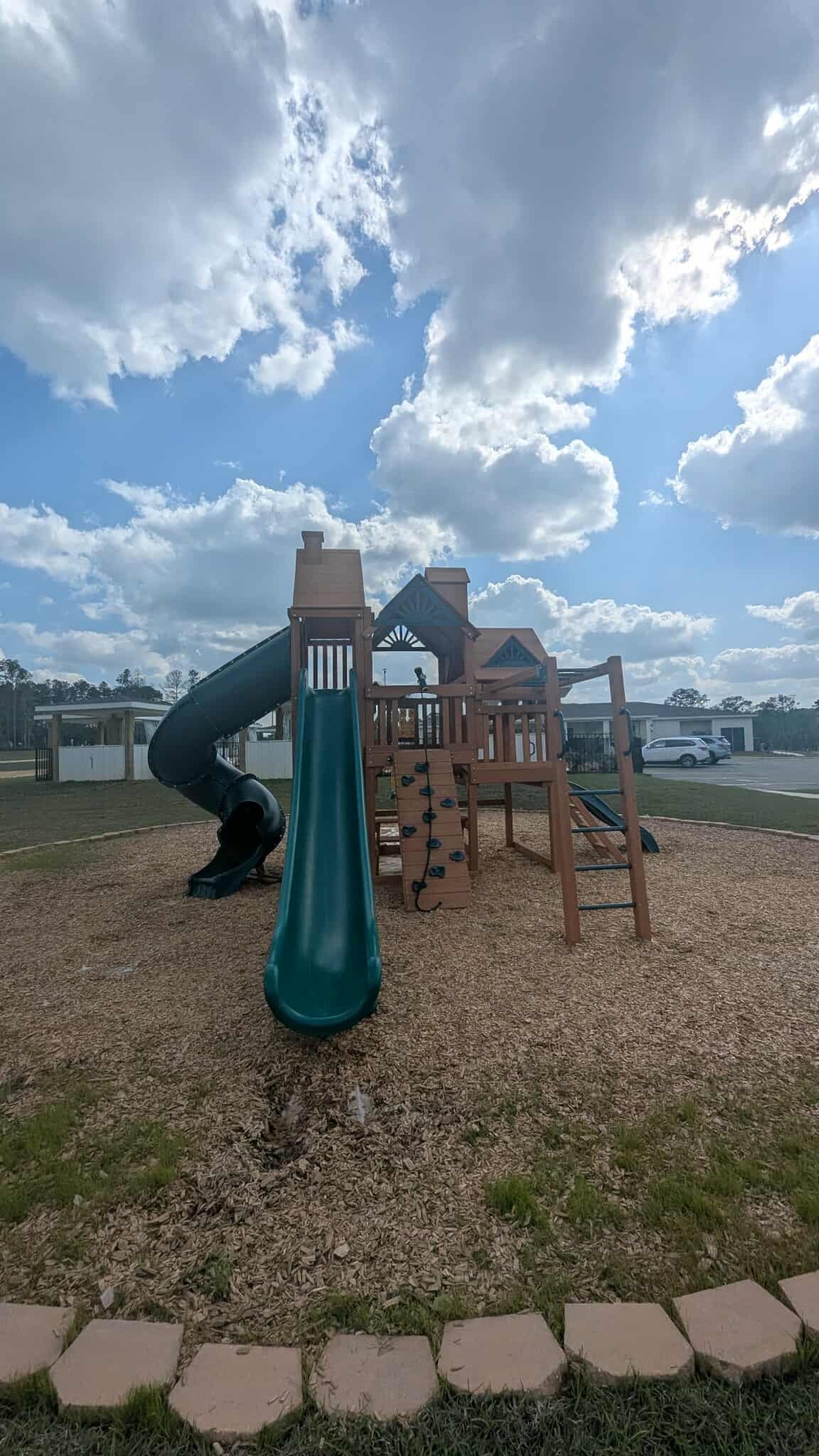 Inviting playground with dynamic slides and climbing walls set against a bright blue sky, perfect for family fun and community gatherings.