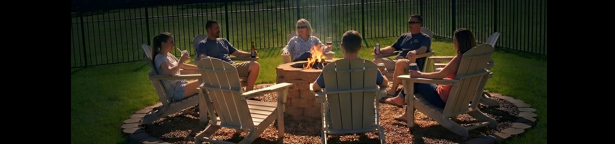 Charming outdoor fire pit gathering area with comfortable seating, perfect for socializing under a starlit sky.