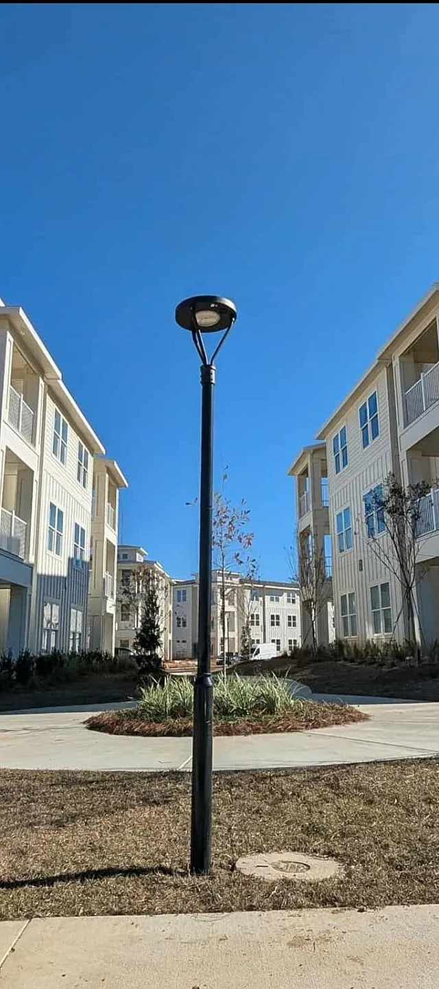 Contemporary apartment complex featuring charming balconies, tranquil pathways, and a serene sunny landscape.
