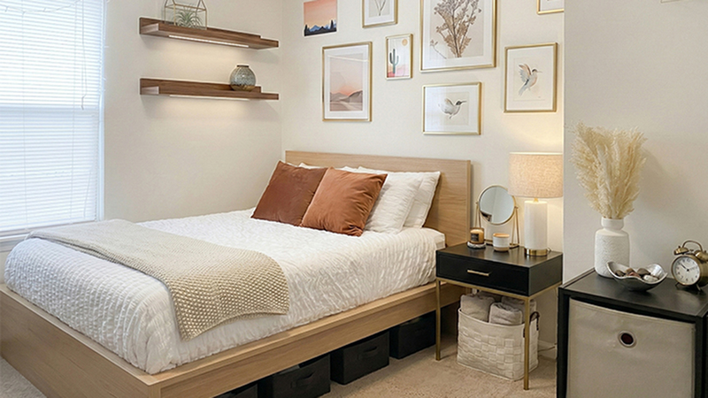 Cozy bedroom featuring a stylish bed with plush pillows, elegant wall art, and modern shelving in a bright, inviting space.