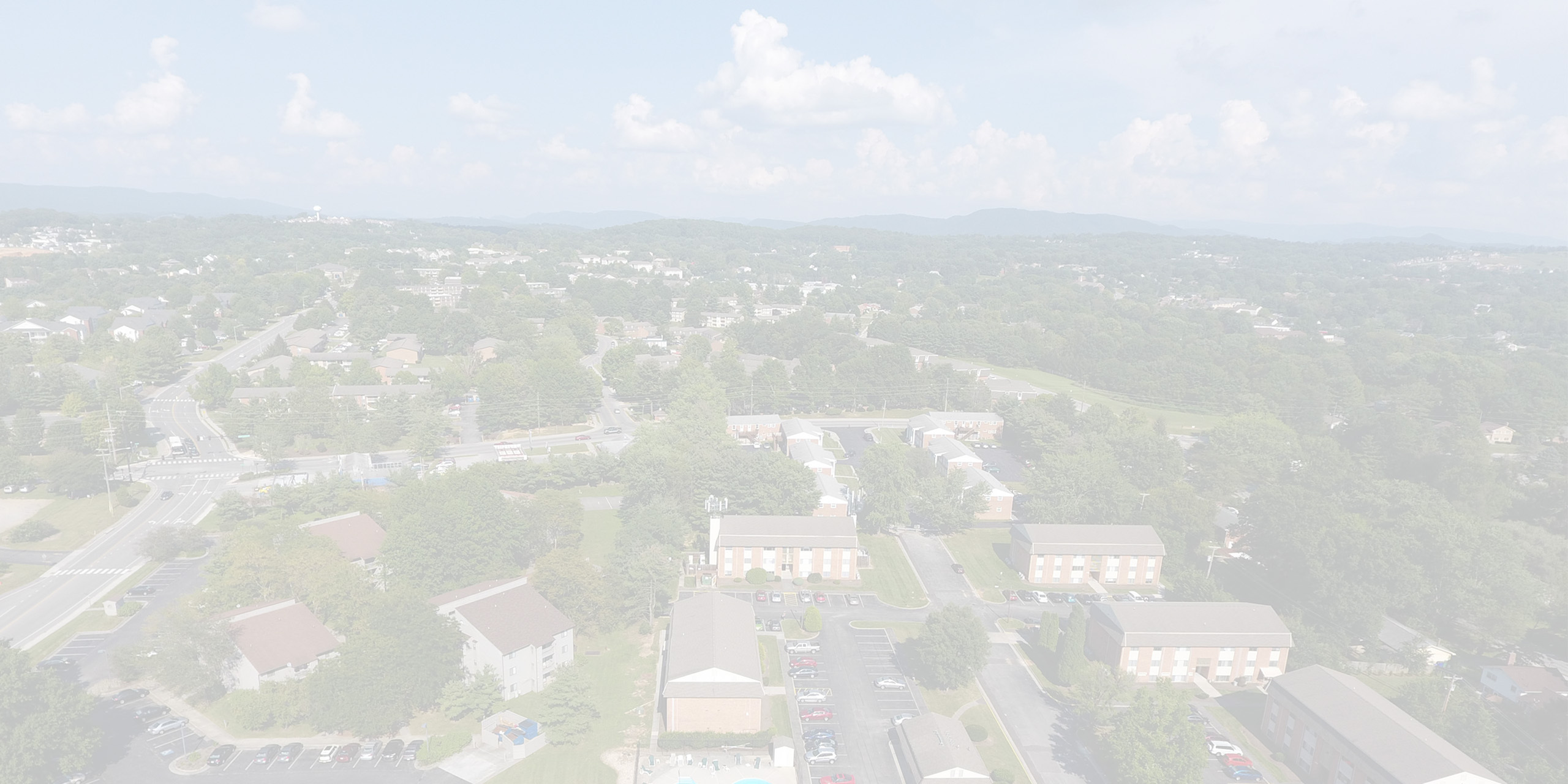 Aerial view of a vibrant neighborhood with lush greenery, well-planned streets, and charming residential buildings.