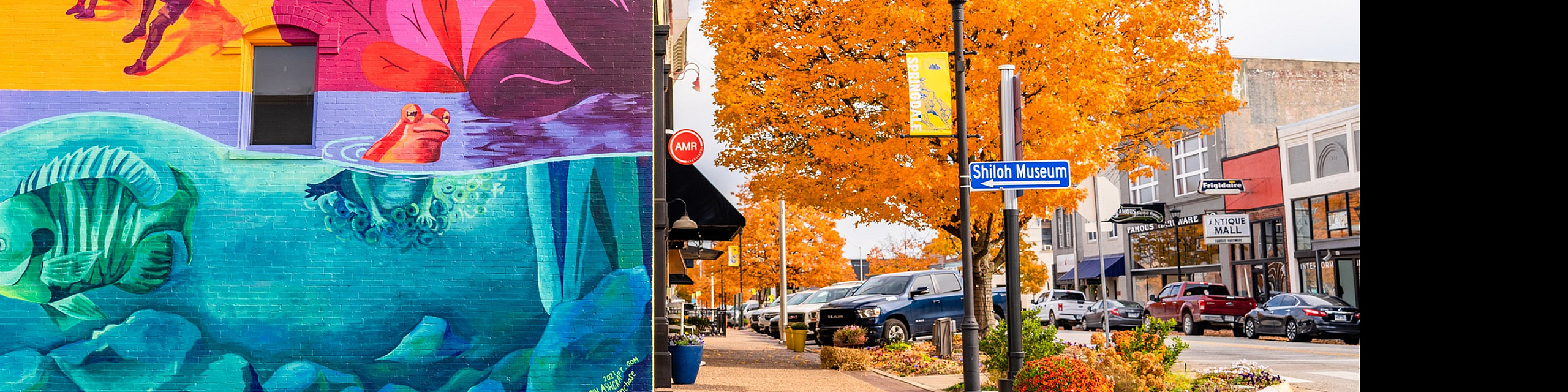 Vibrant mural and vivid autumn foliage on a lively street corner near Shiloh Museum, capturing the essence of local culture and color.