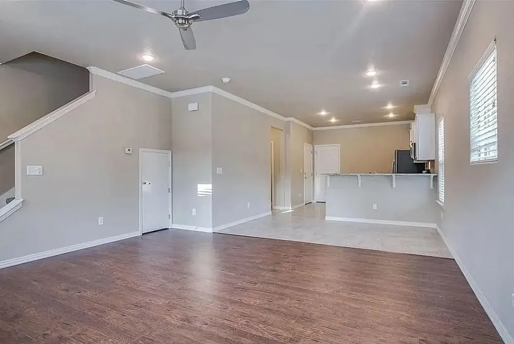 Charming kitchen with modern stainless steel appliances, ample wooden cabinetry, and elegant tile flooring, offering a warm and inviting cooking space.