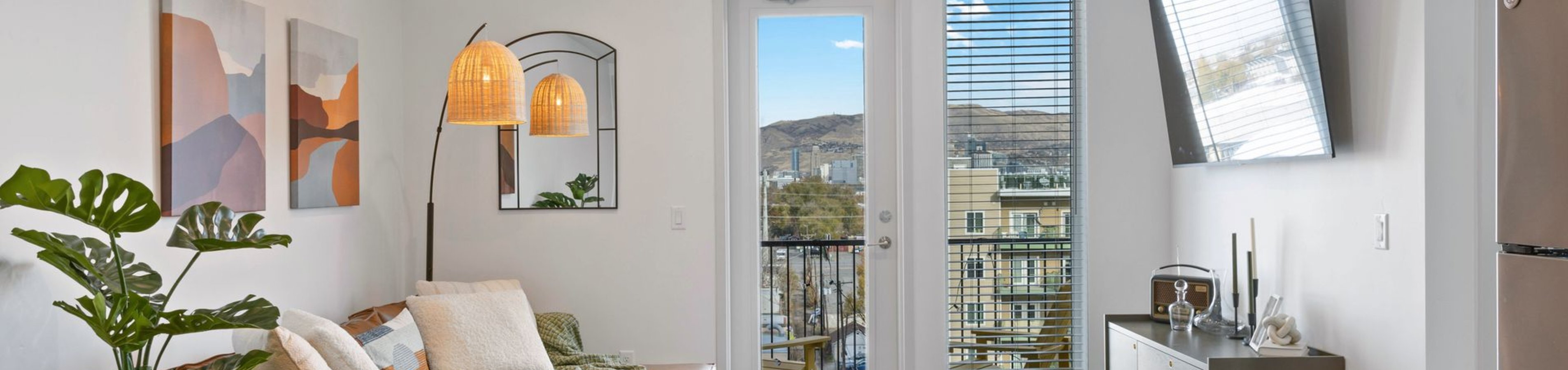 Bright and inviting living room with contemporary decor, featuring large windows with scenic mountain views.